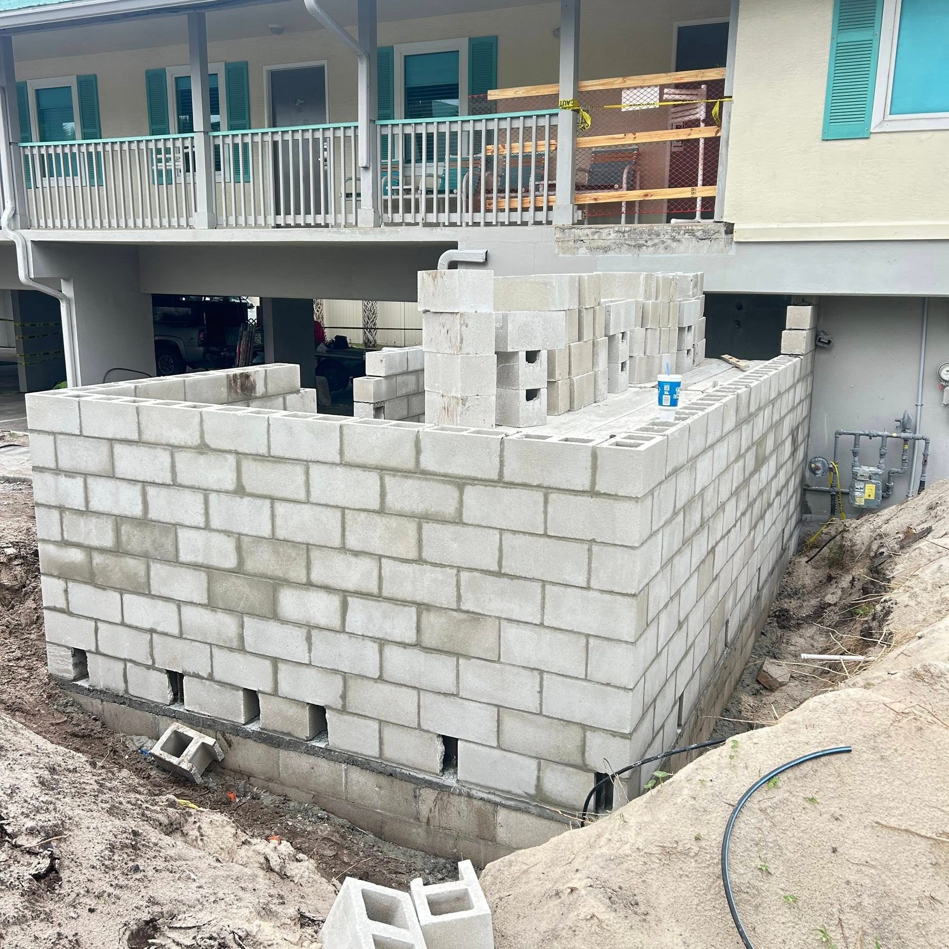 Building construction site with cinder block walls.