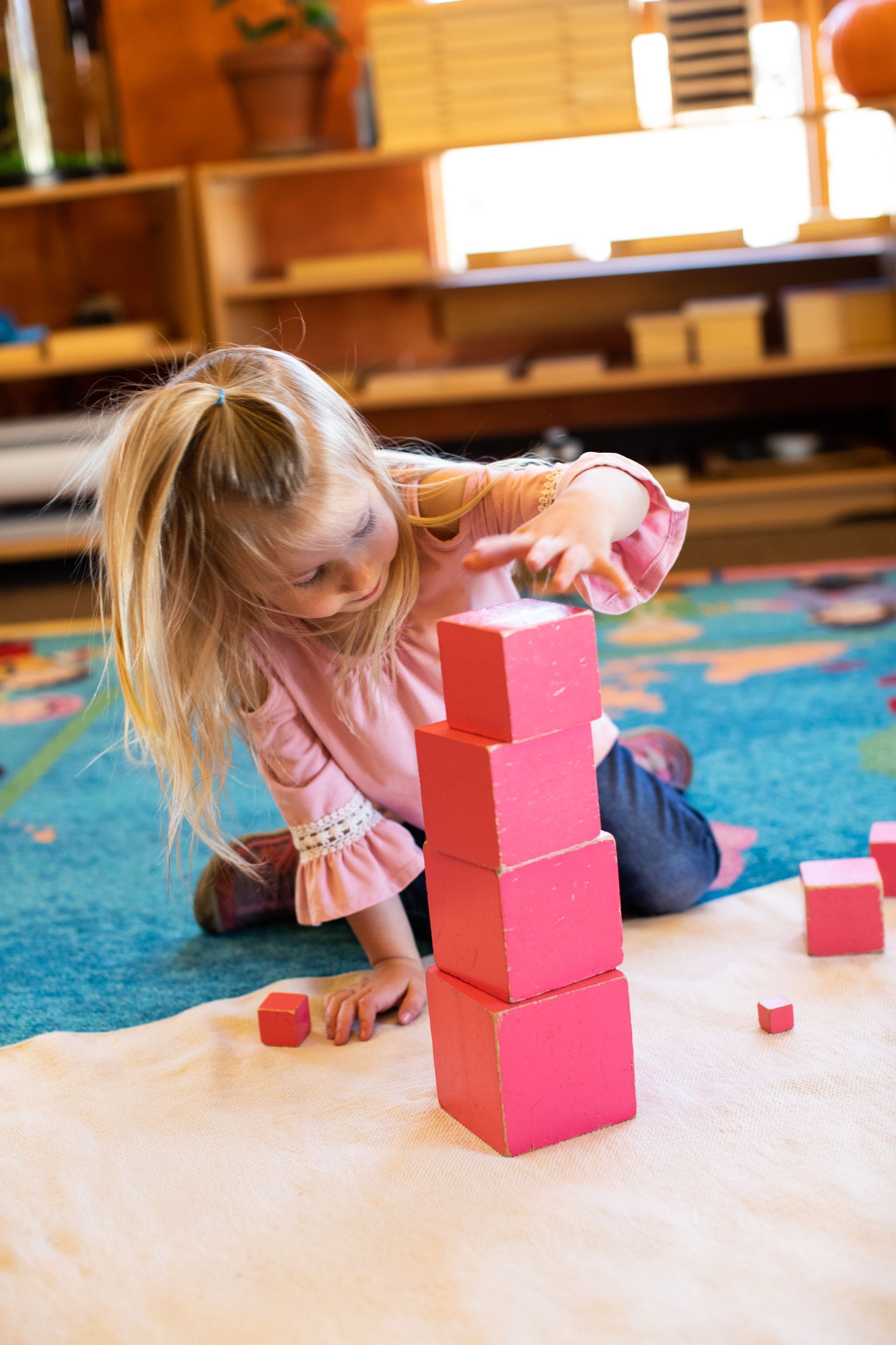 Child working with the Montessori pink tower