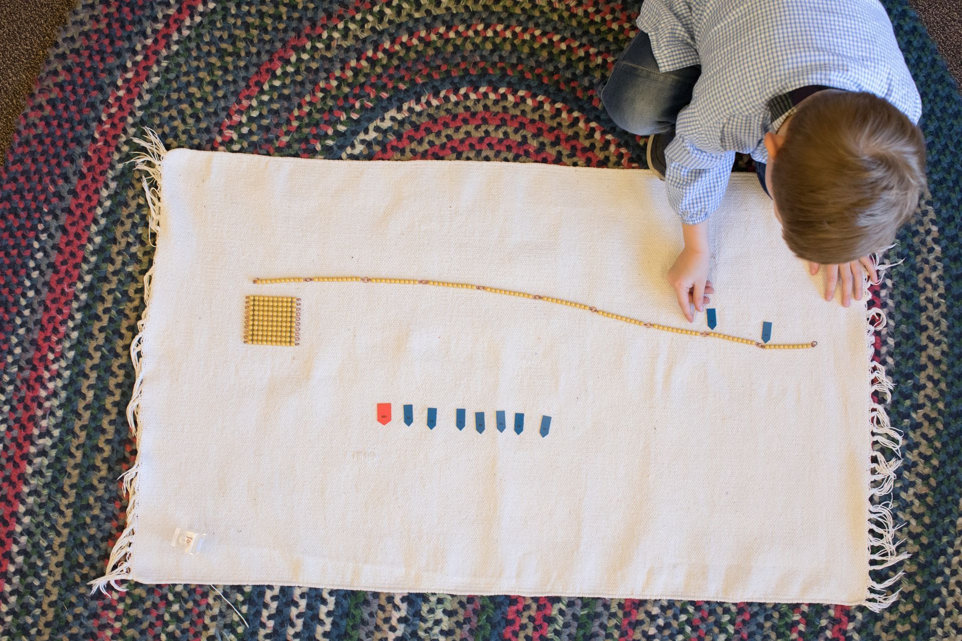 Child working with Montessori math beads 