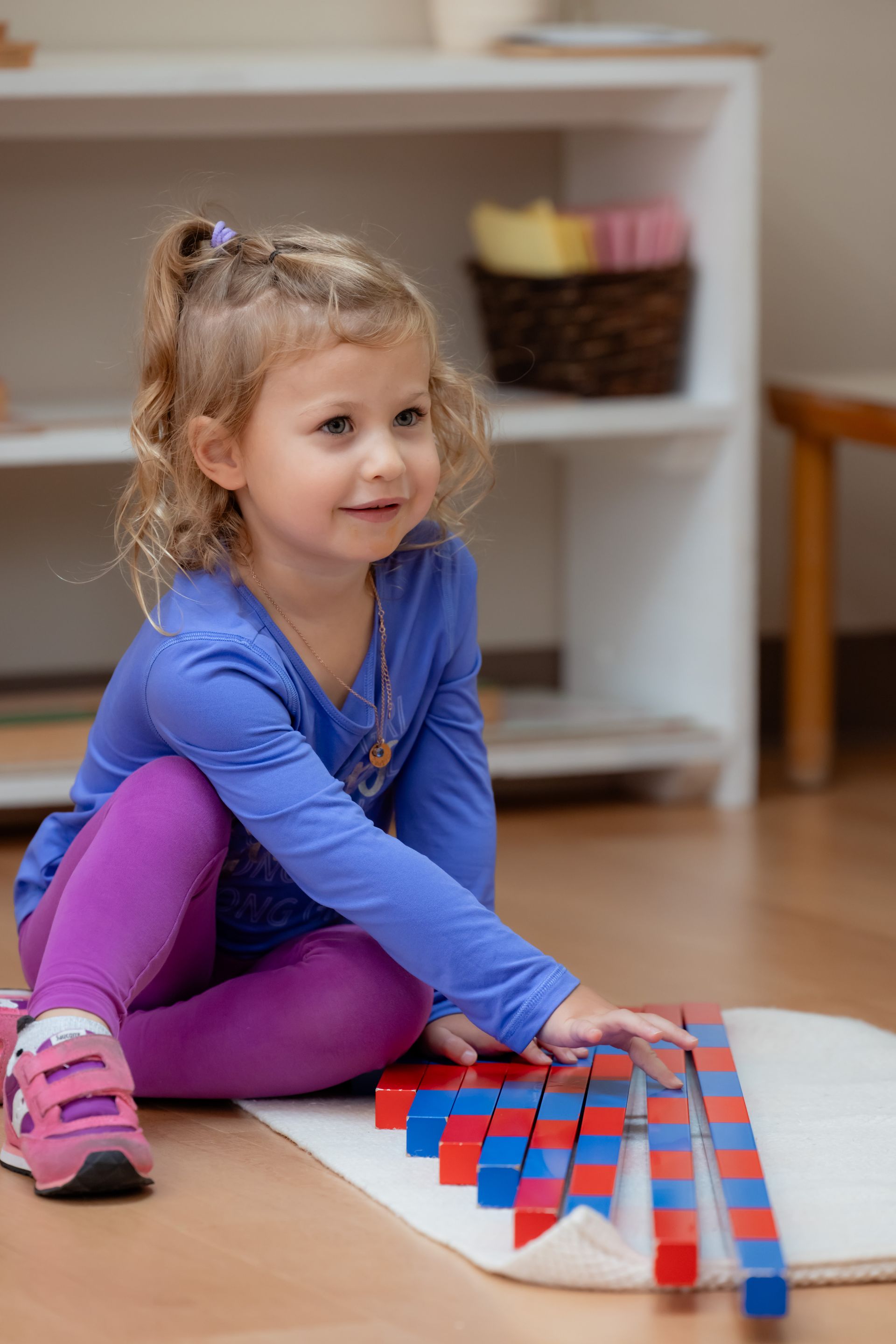 Montessori child working with sensorial materials