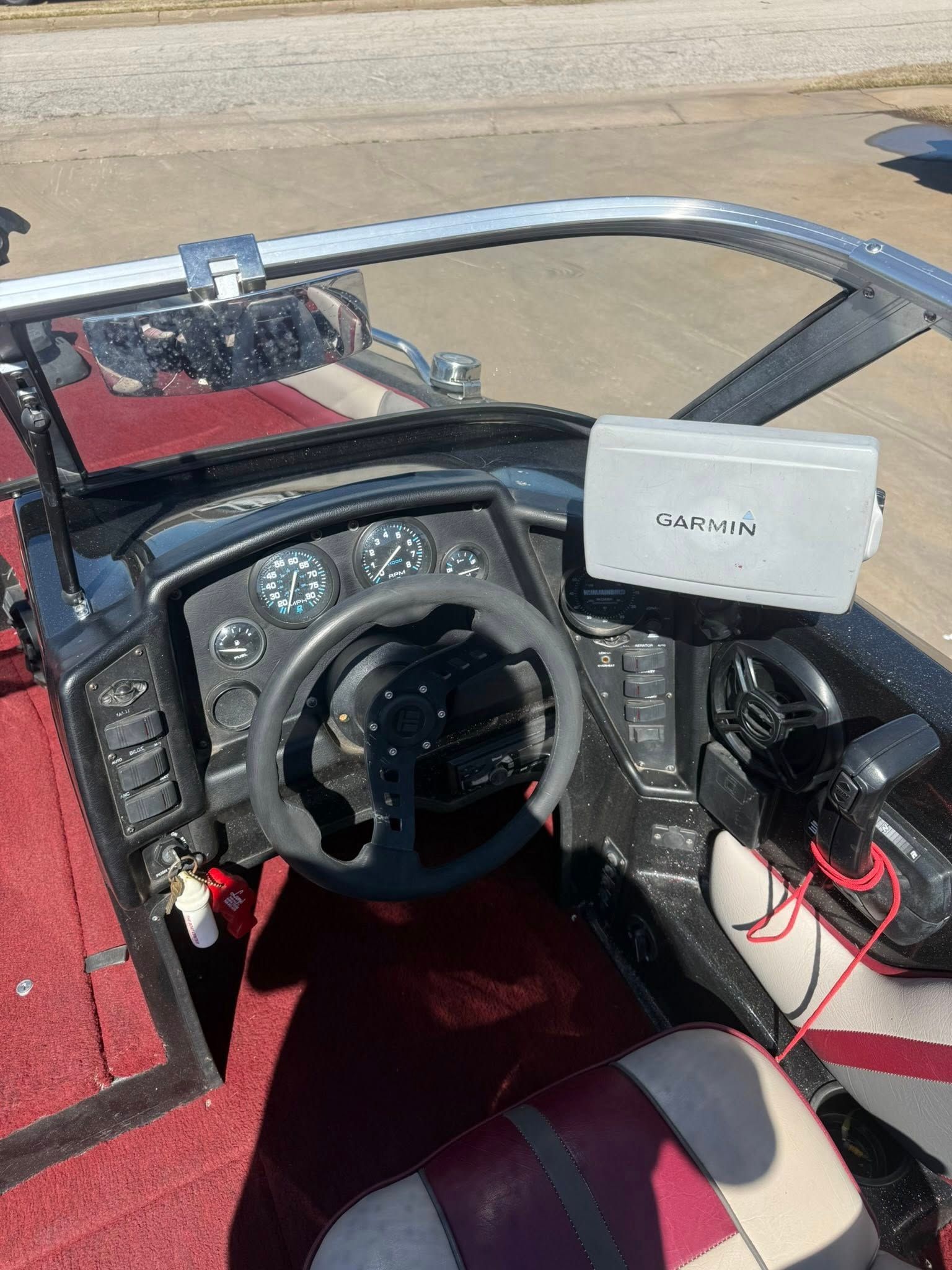 Cockpit view of a red buggy with steering wheel, dashboard, and white tablet mounted on the right