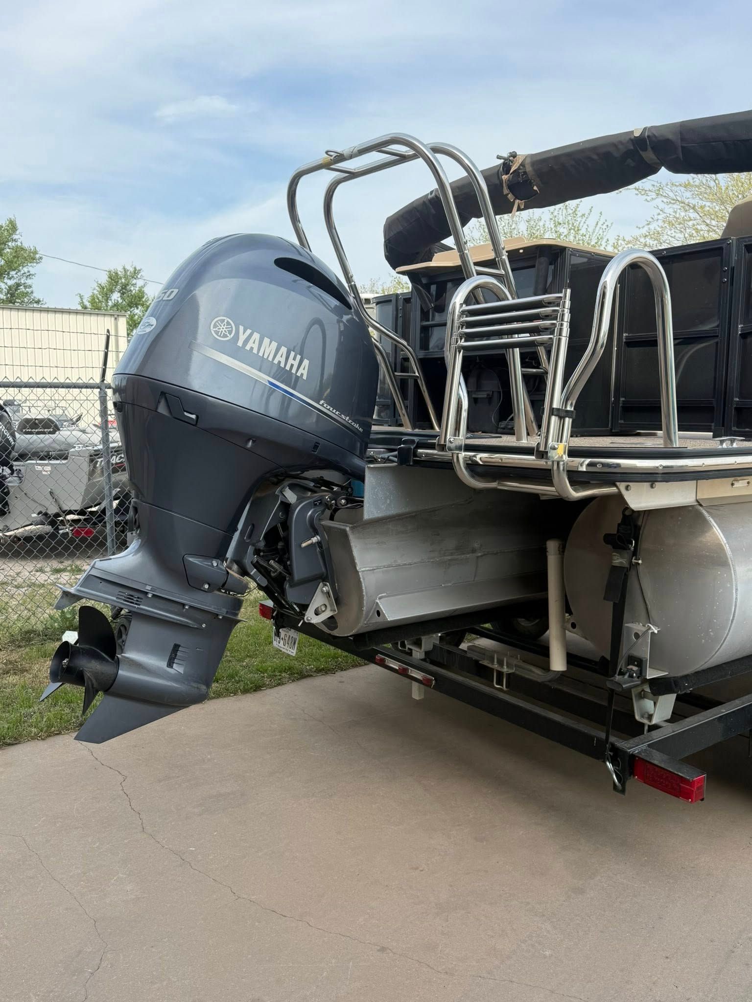 Yamaha outboard motor mounted on the stern of a boat on a trailer outdoors