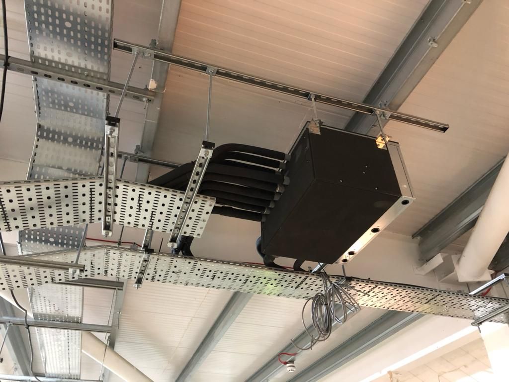 A ceiling with a lot of wires hanging from it