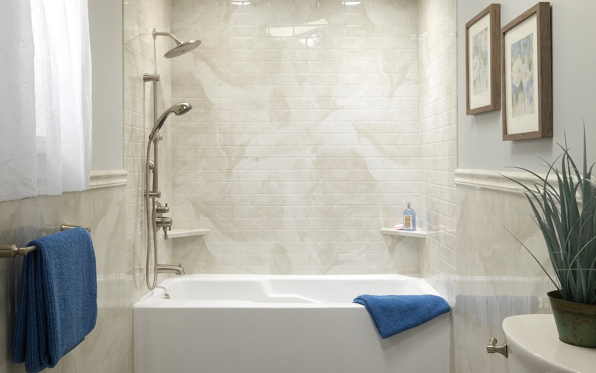Bright bathroom with a white tub, tiled shower, blue towels, and a potted plant.