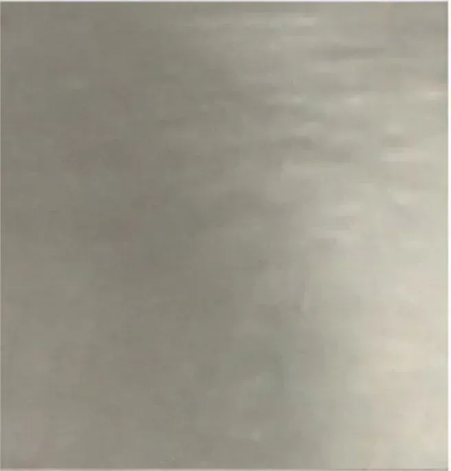 Blurred gray-beige surface with soft light and no distinct objects.