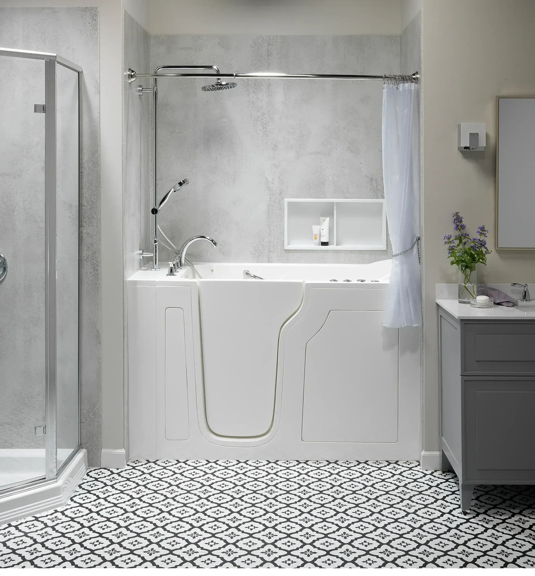 Modern white bathroom with walk-in shower, freestanding tub, patterned black-and-white floor, and gray vanity.