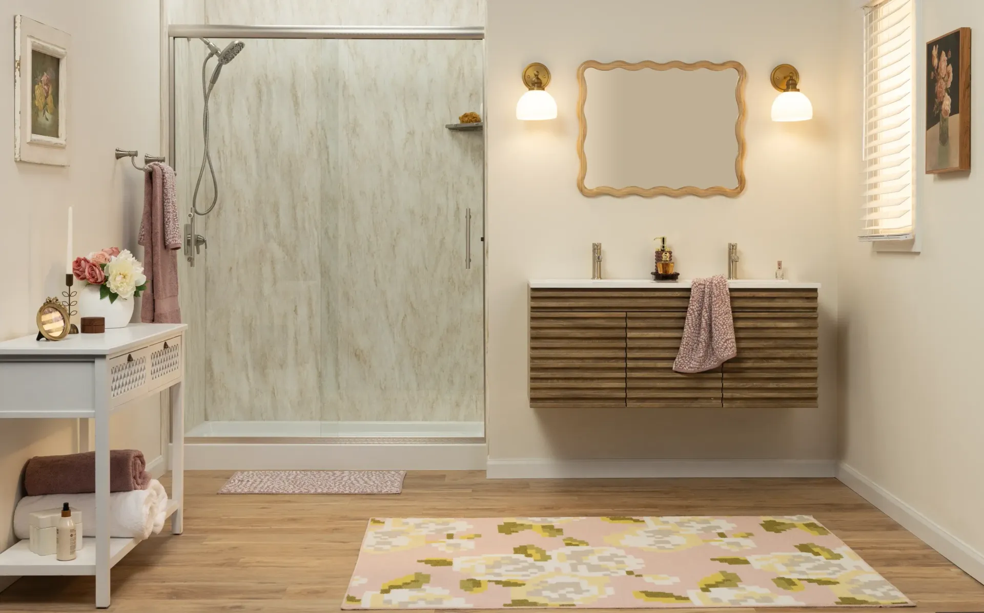 Bright spa bathroom with glass shower, wall mirror, vanity, and pastel rug on wood floor