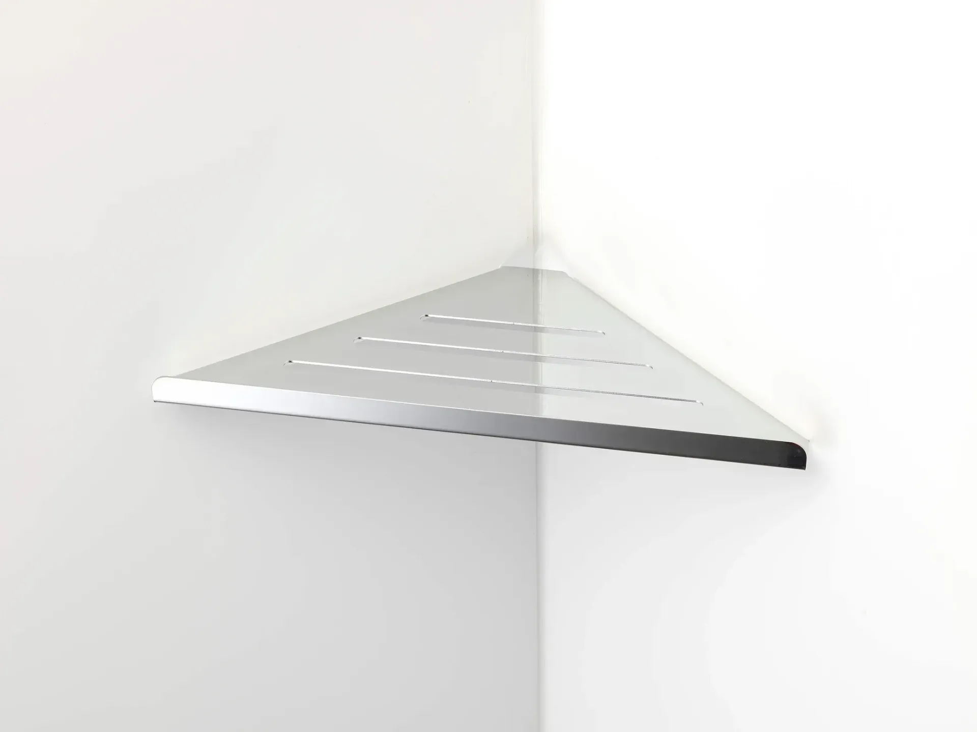 White triangular corner shelf mounted on a wall