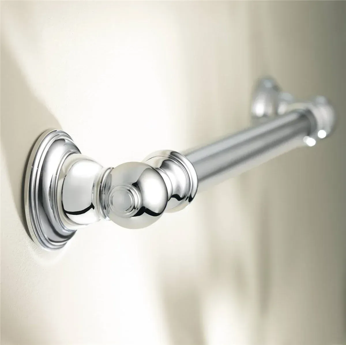Chrome towel bar on a beige wall