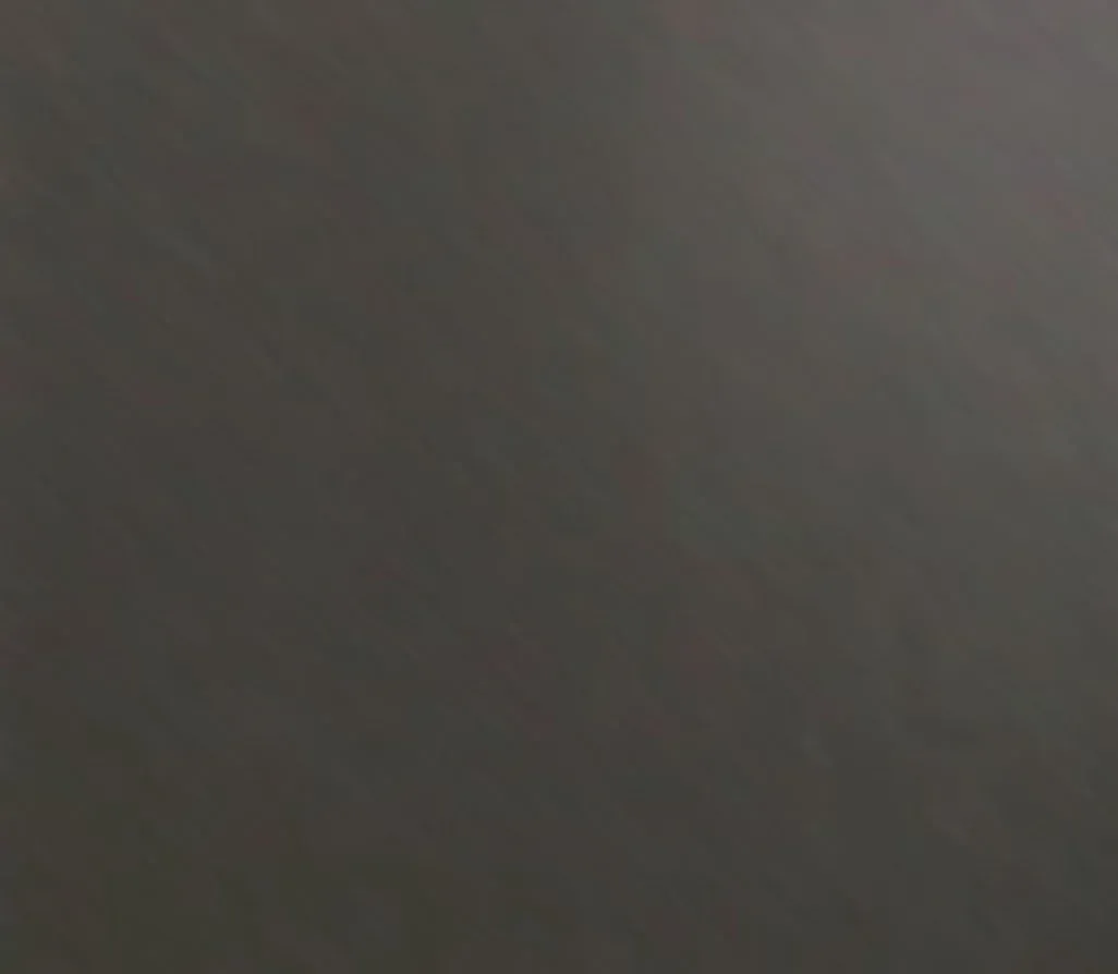 Blurred gray-brown gradient with no distinct objects or subjects visible