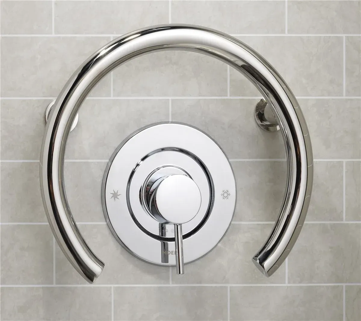 Chrome shower control valve with curved grab bar on gray tiled wall