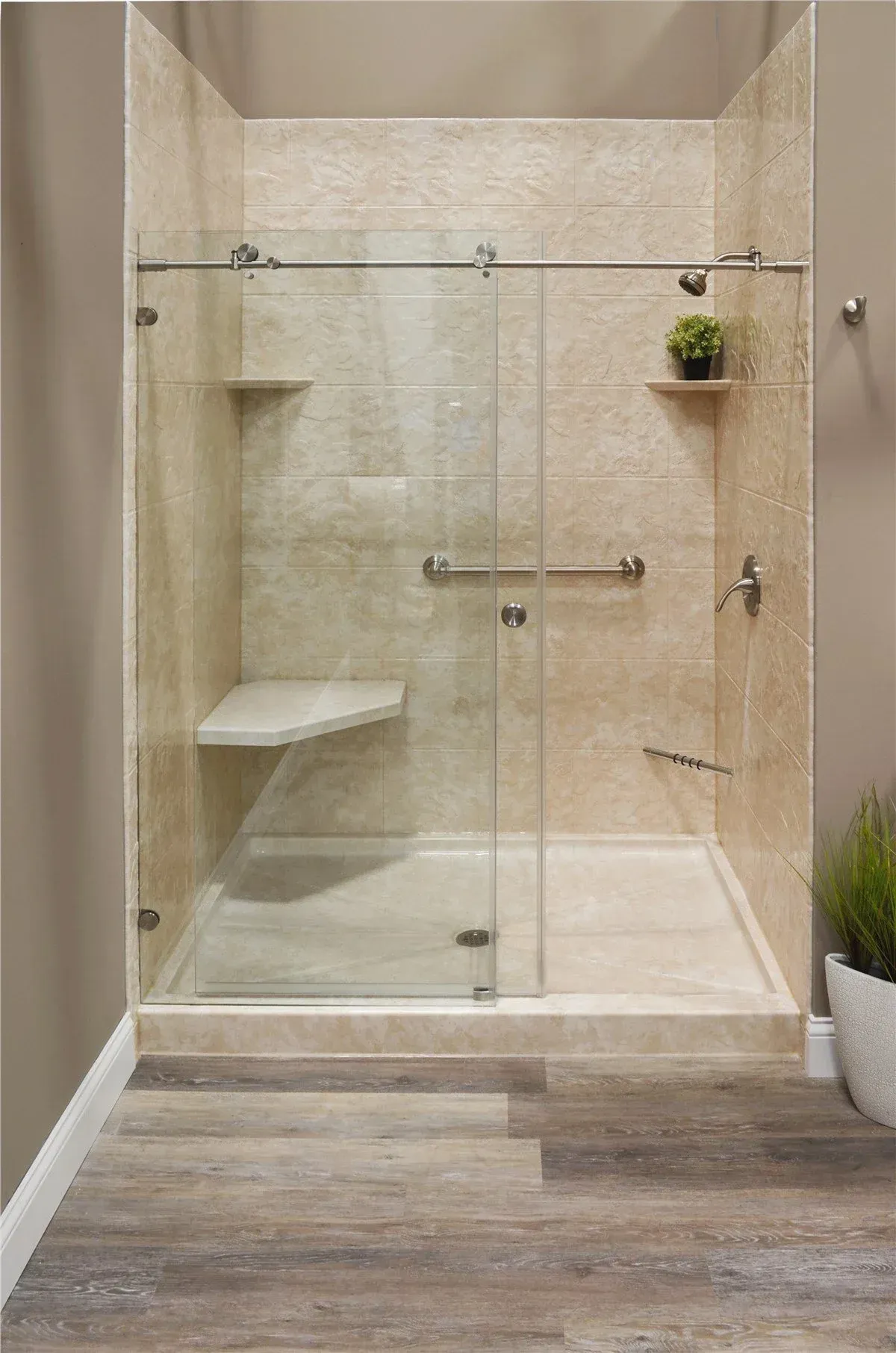 Modern beige walk-in shower with glass doors, tiled walls, and a built-in bench.