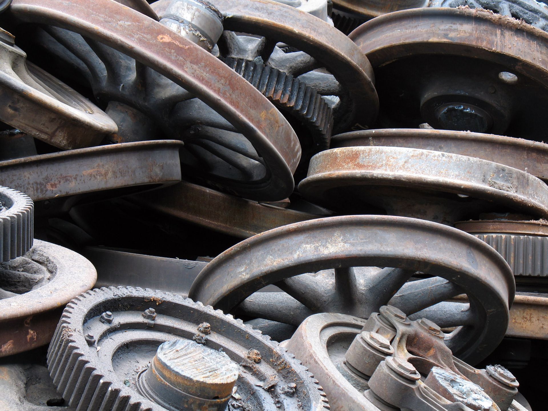 Pile of rusty industrial gears and wheels.