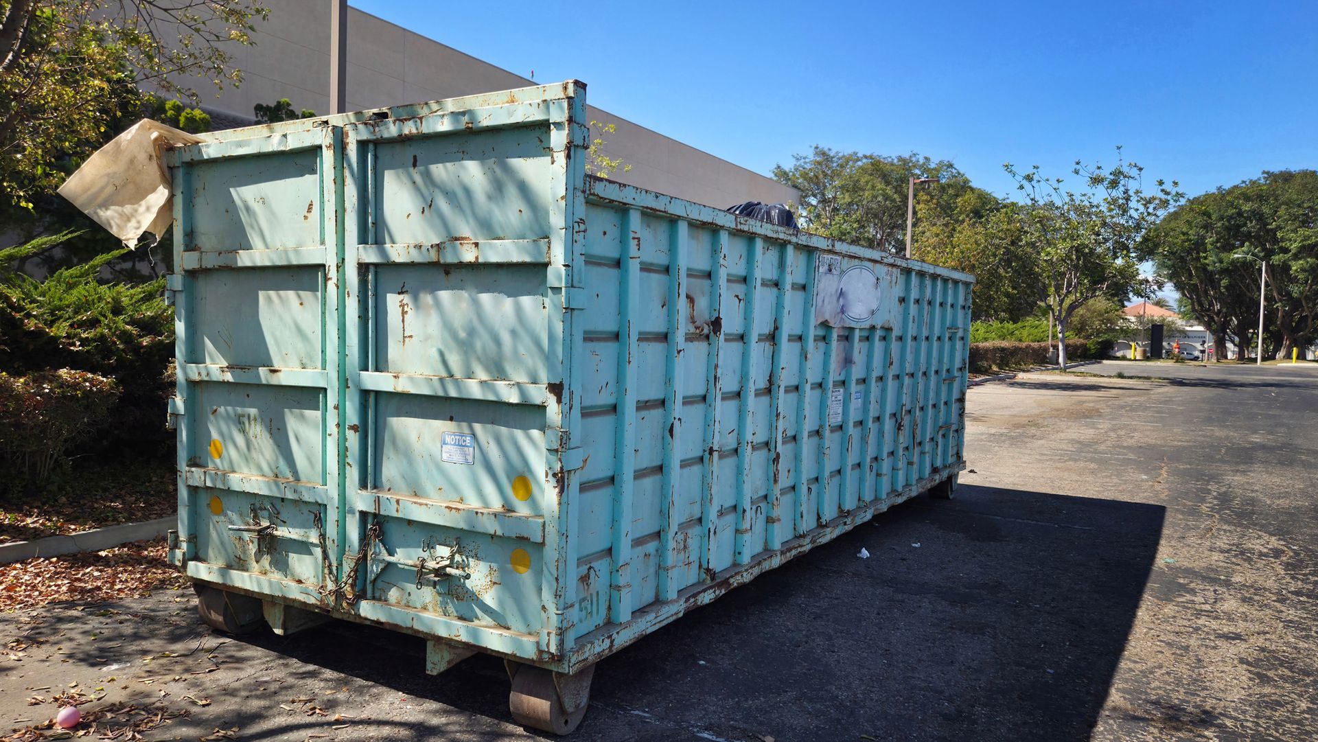 A large dumpster near a construction site. A large dumpster near a construction site.