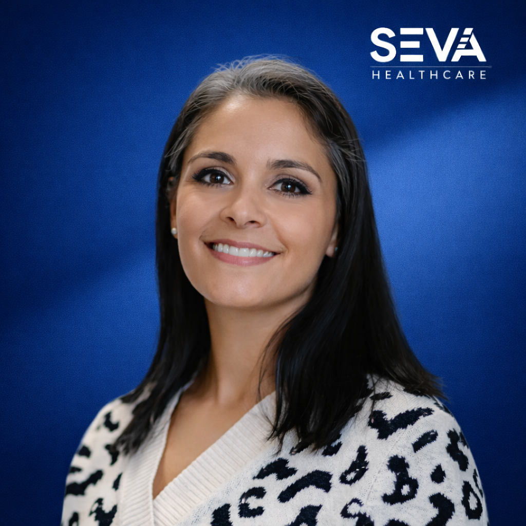 Portrait of a smiling woman against a blue backdrop with the SEVA Healthcare logo.