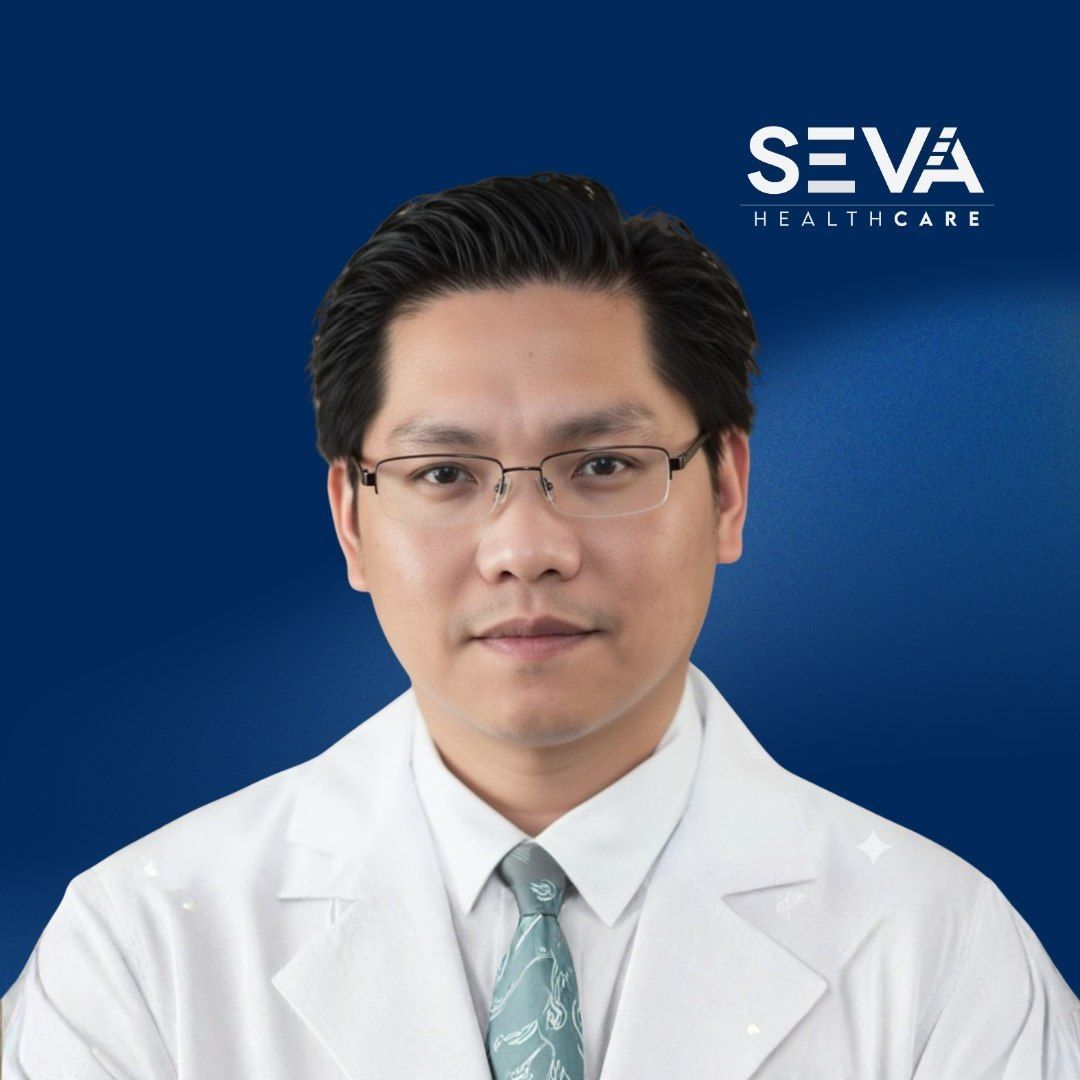 Professional headshot of a doctor in a white coat against a blue background with SEVA Healthcare logo
