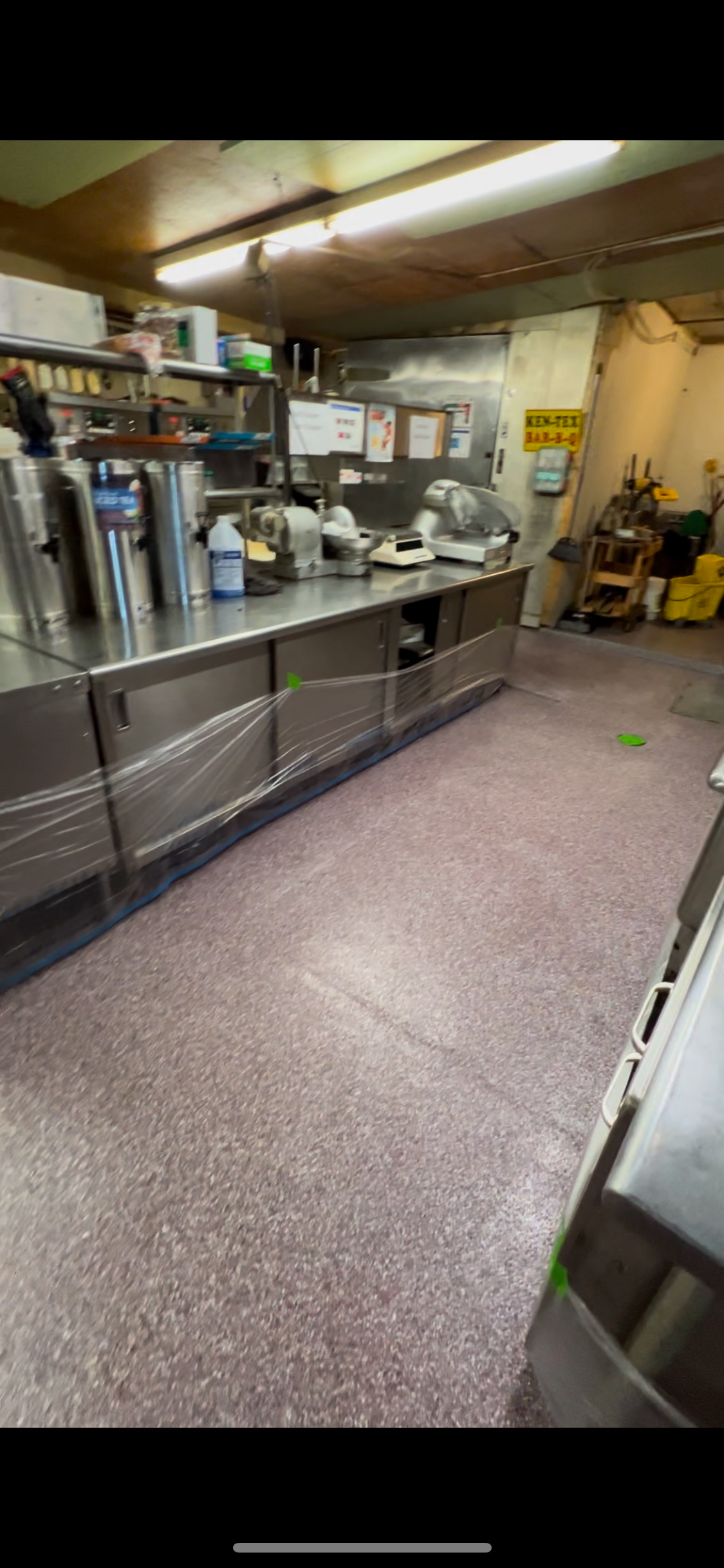 A commercial kitchen with stainless steel counters and flooring.