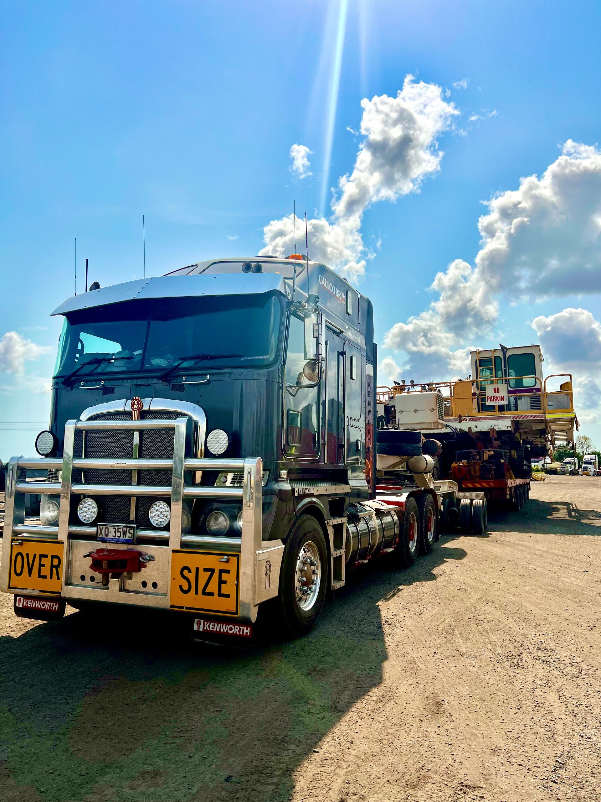 Oversized transport truck hauling heavy machinery.