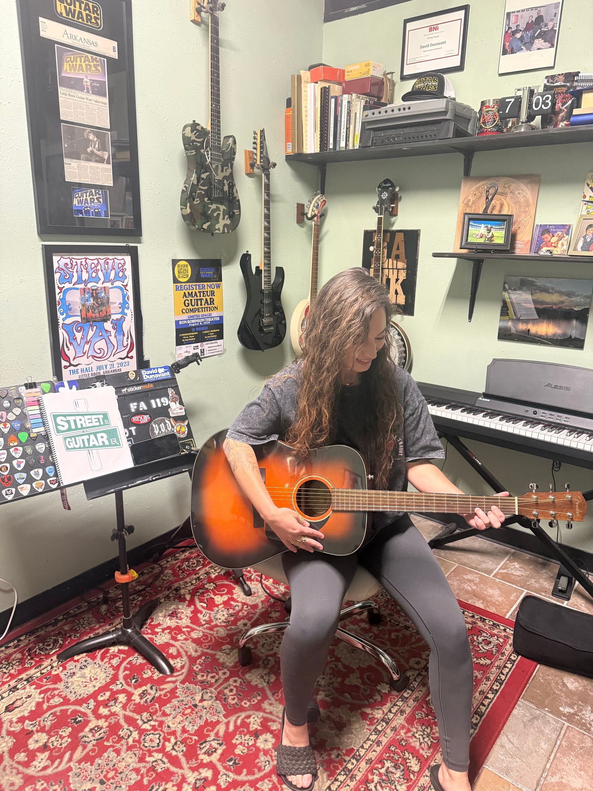 A female student practicing guitar in David Dunavant's guitar studio.