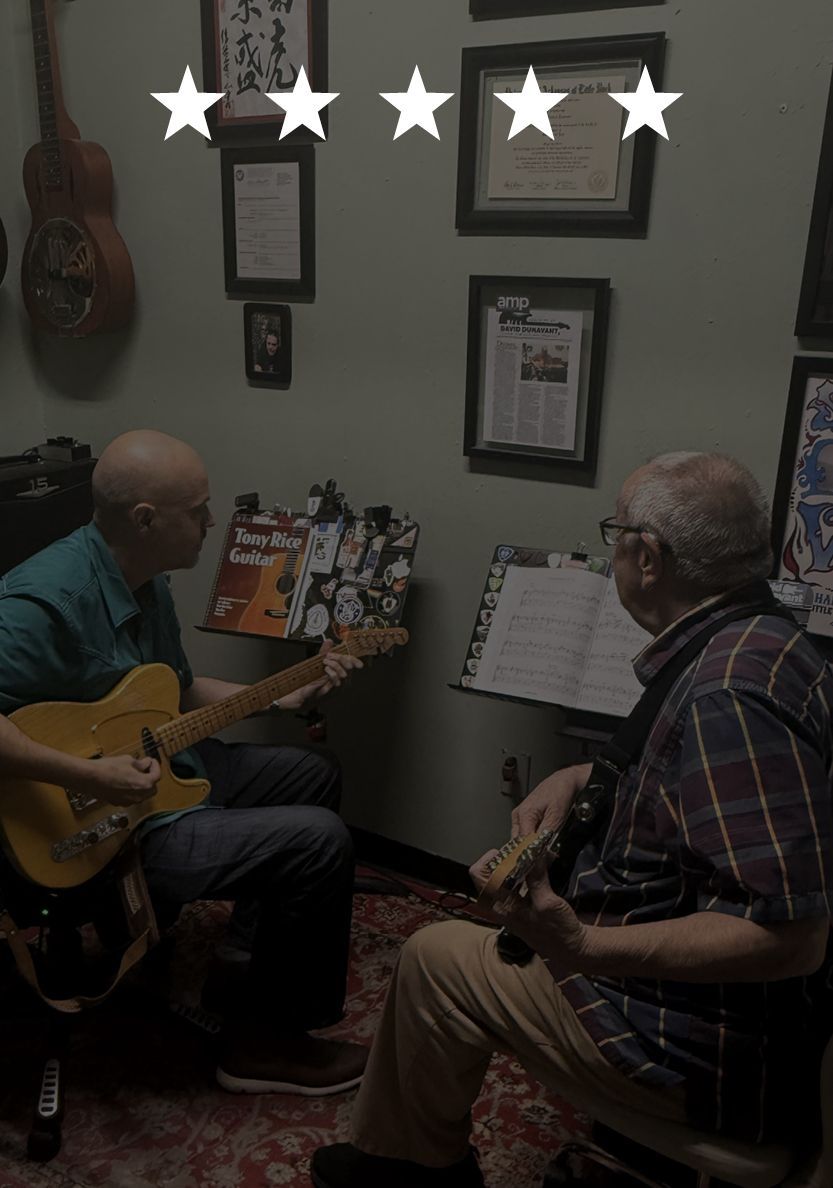 David is teaching an adult student in the studio.