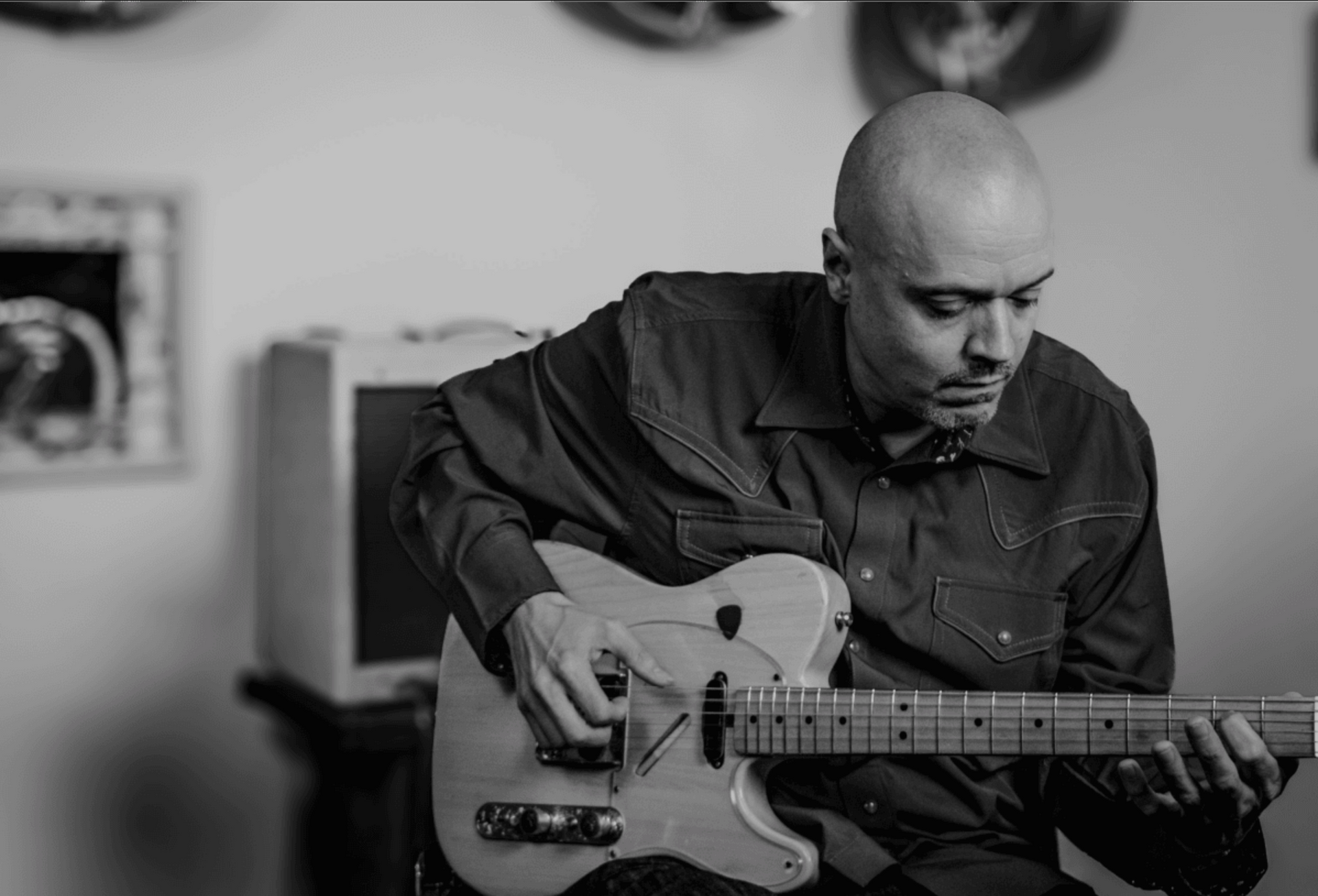 Black-and-white photo of David Dunavant playing guitar.