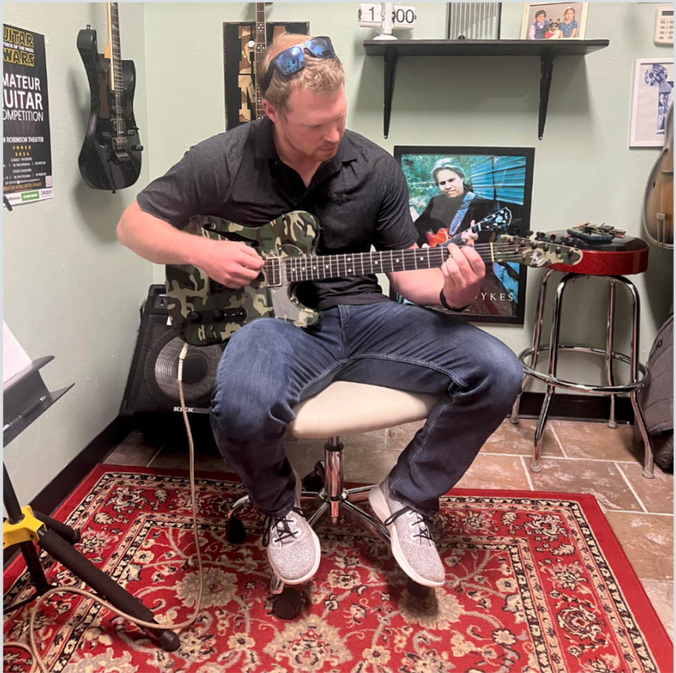 Guitar student demonstrating electric guitar technique during a private lesson in Little Rock