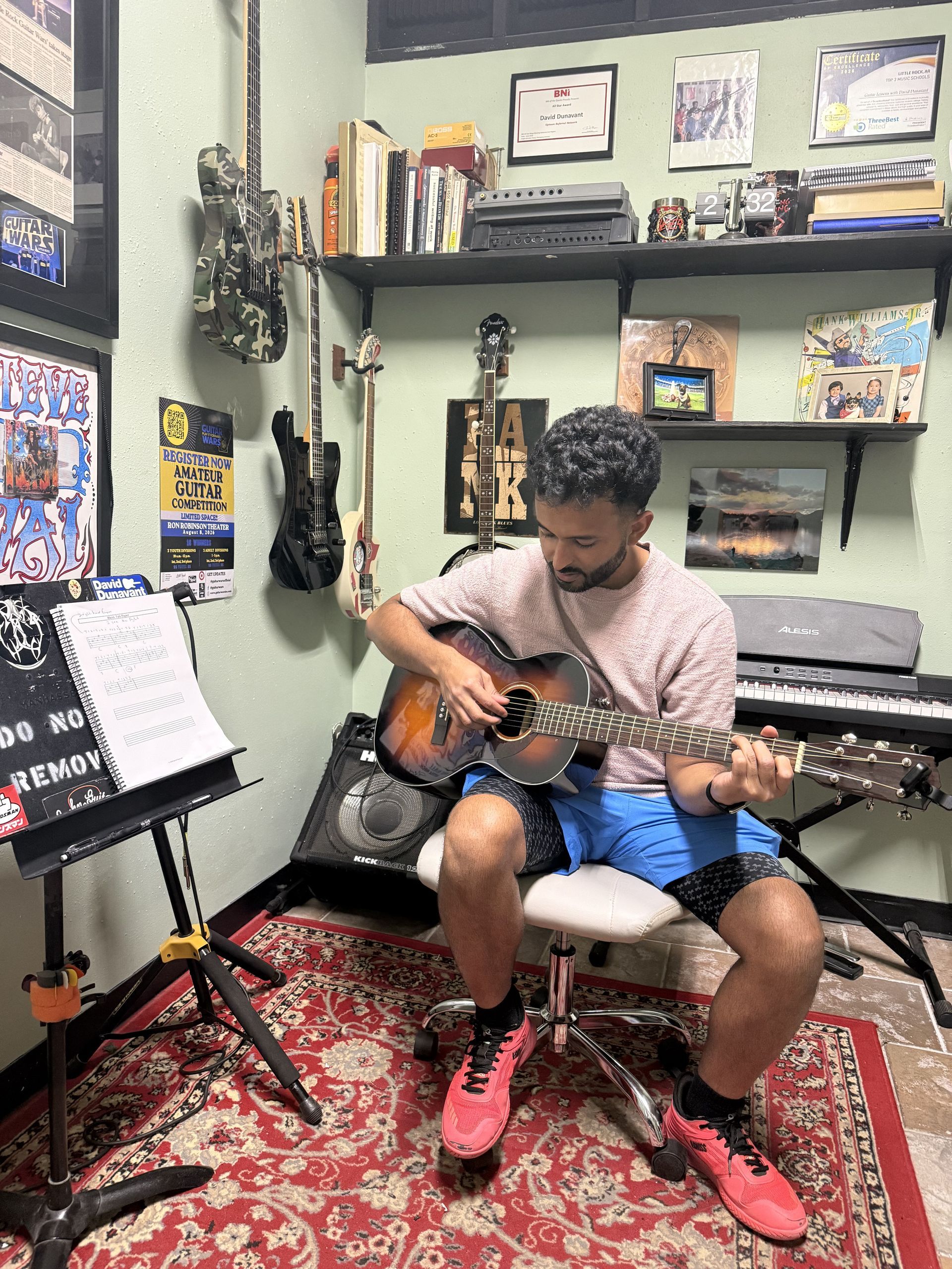 A student practicing guitar in David Dunavant's guitar studio.