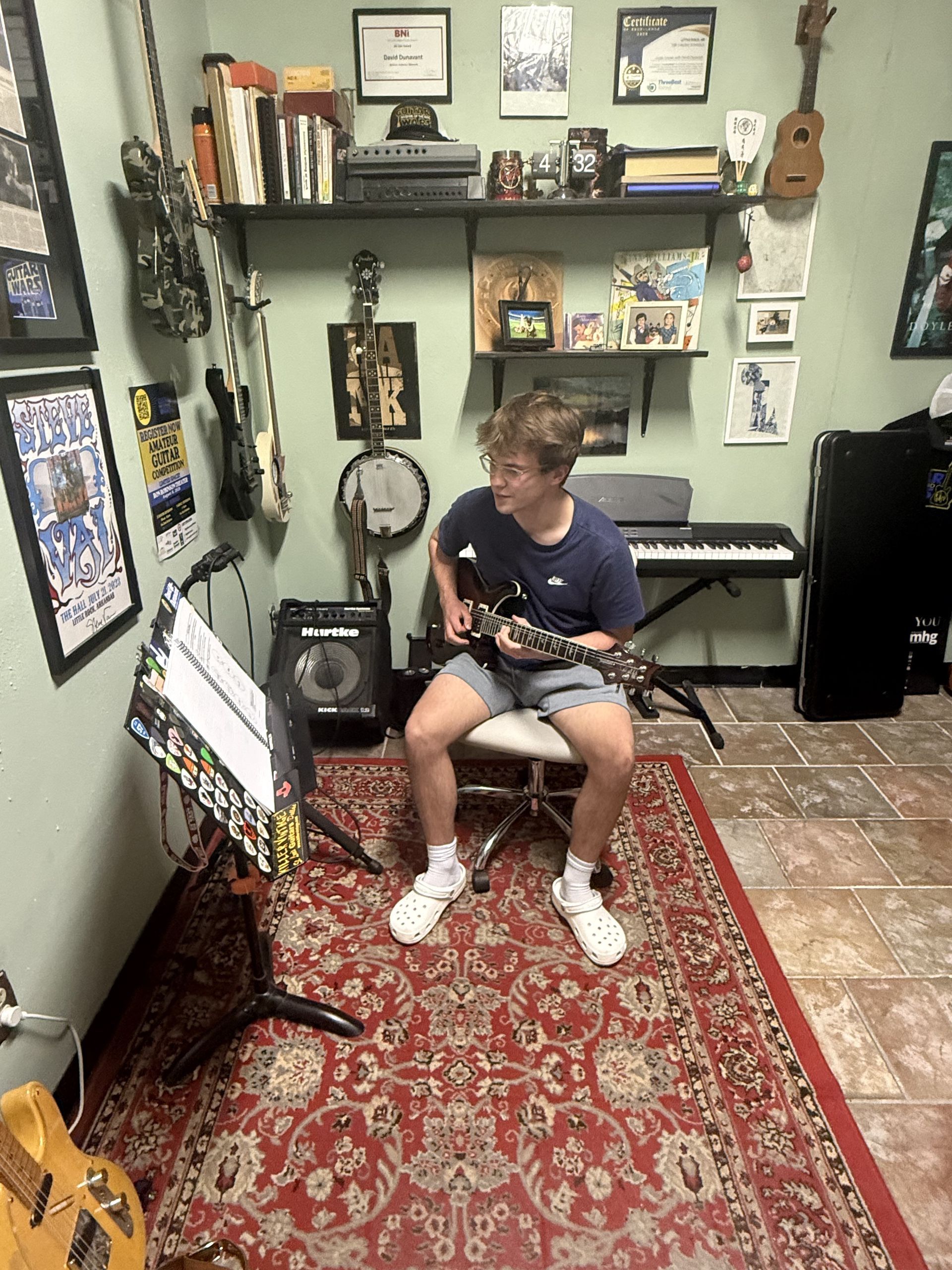 A student practicing guitar in David Dunavant's guitar studio.