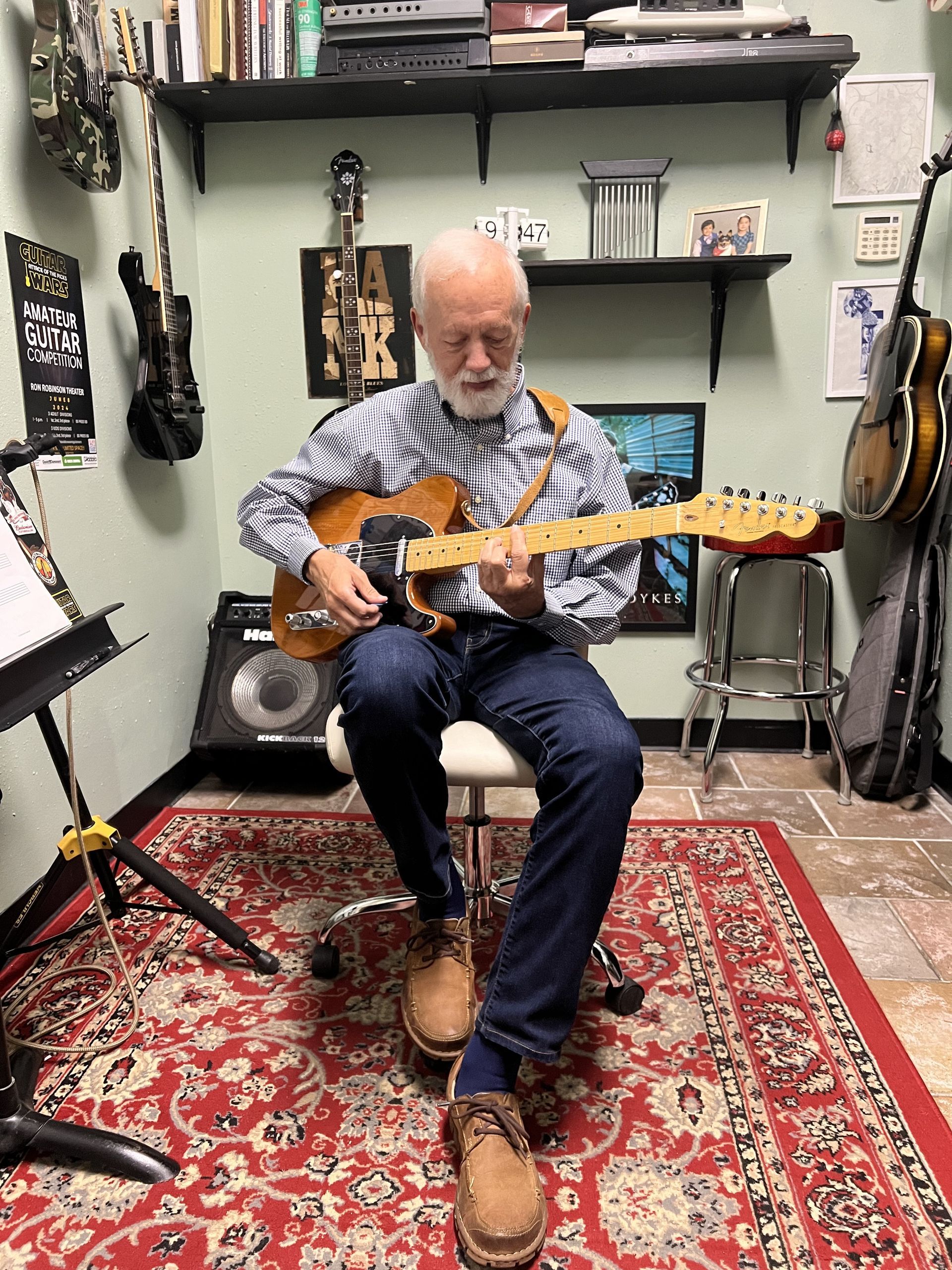 David Dunavant's teaching studio with a student playing the guitar.