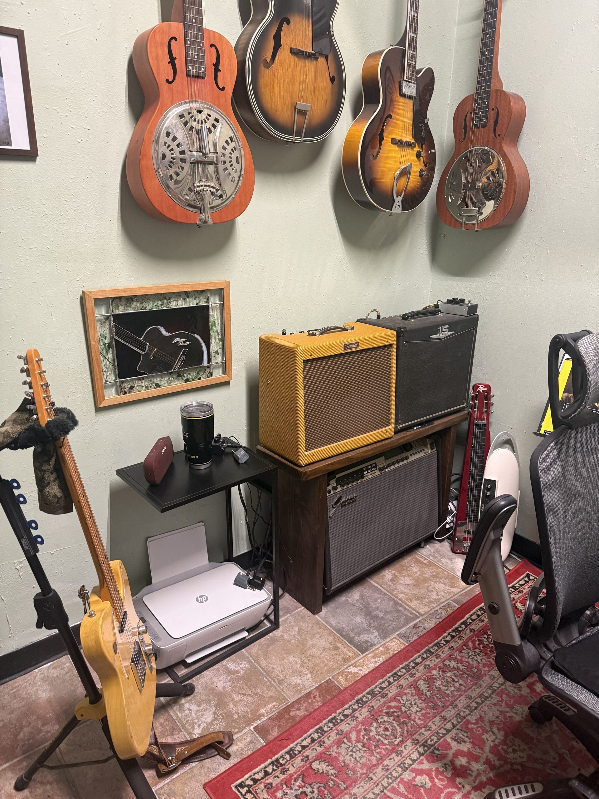 Guitars hanging on the wall and resting on the floor in David Dunavant's teaching studio.