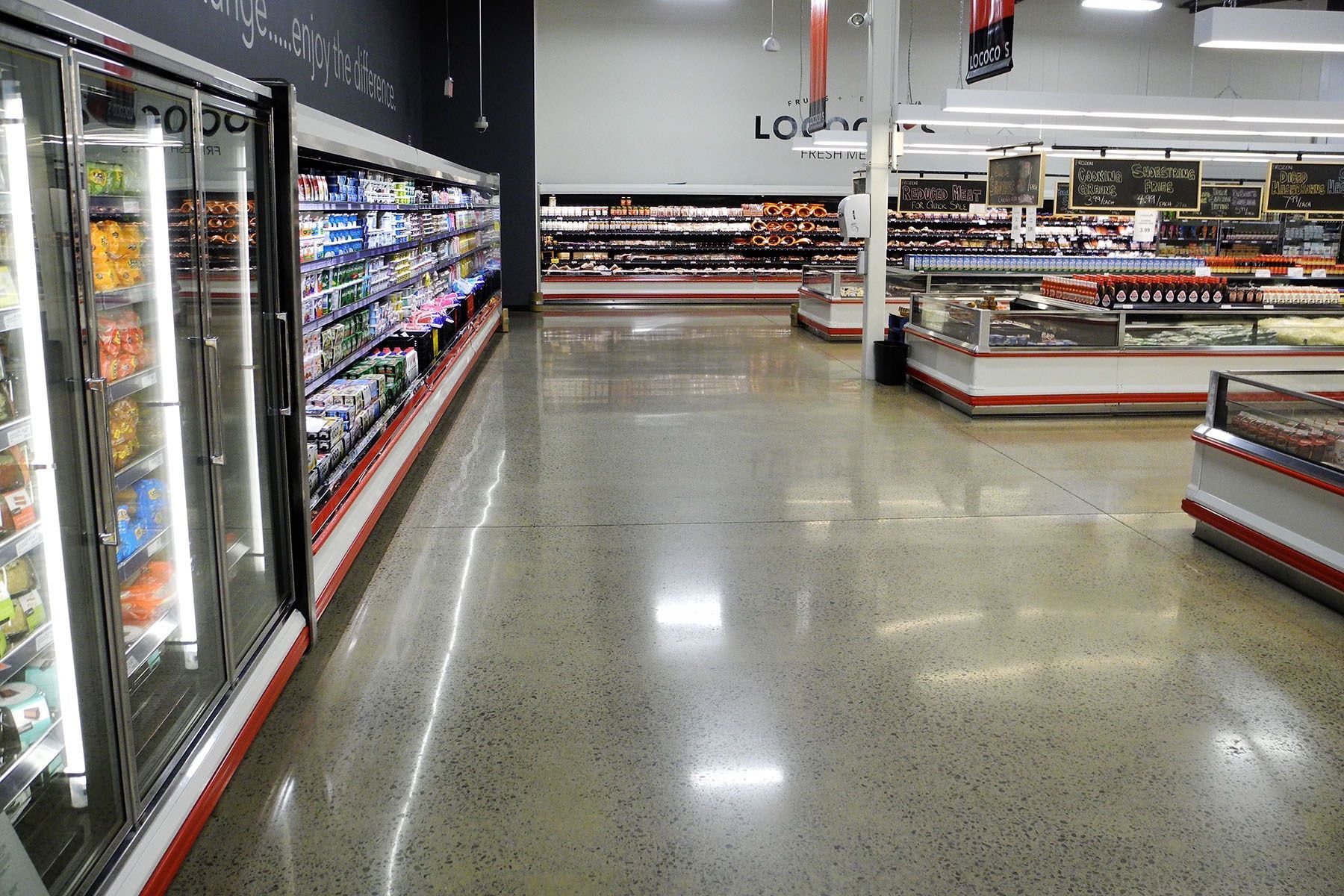 A grocery store with a lot of fridges and shelves