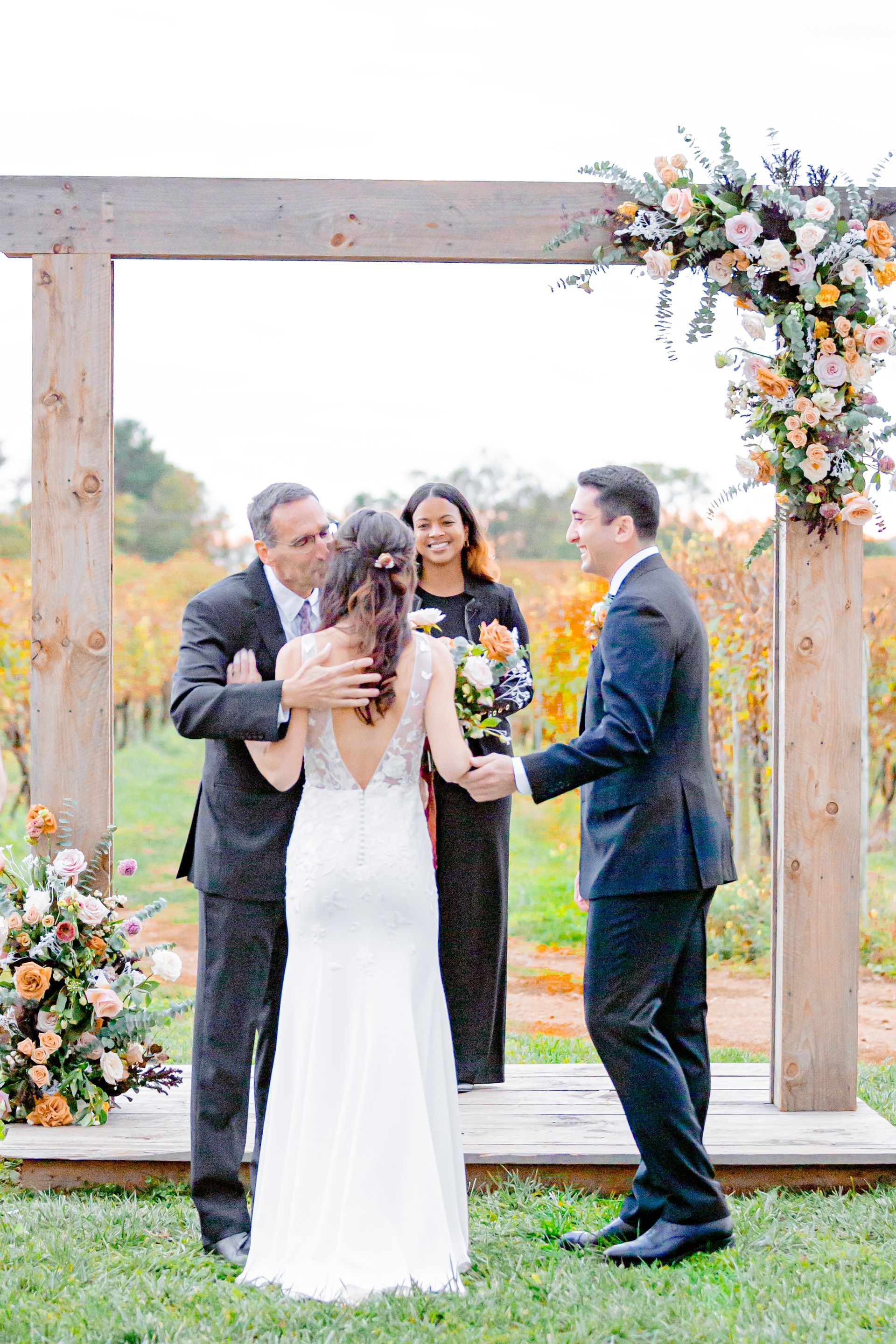 Freinds gathering under the wedding arch