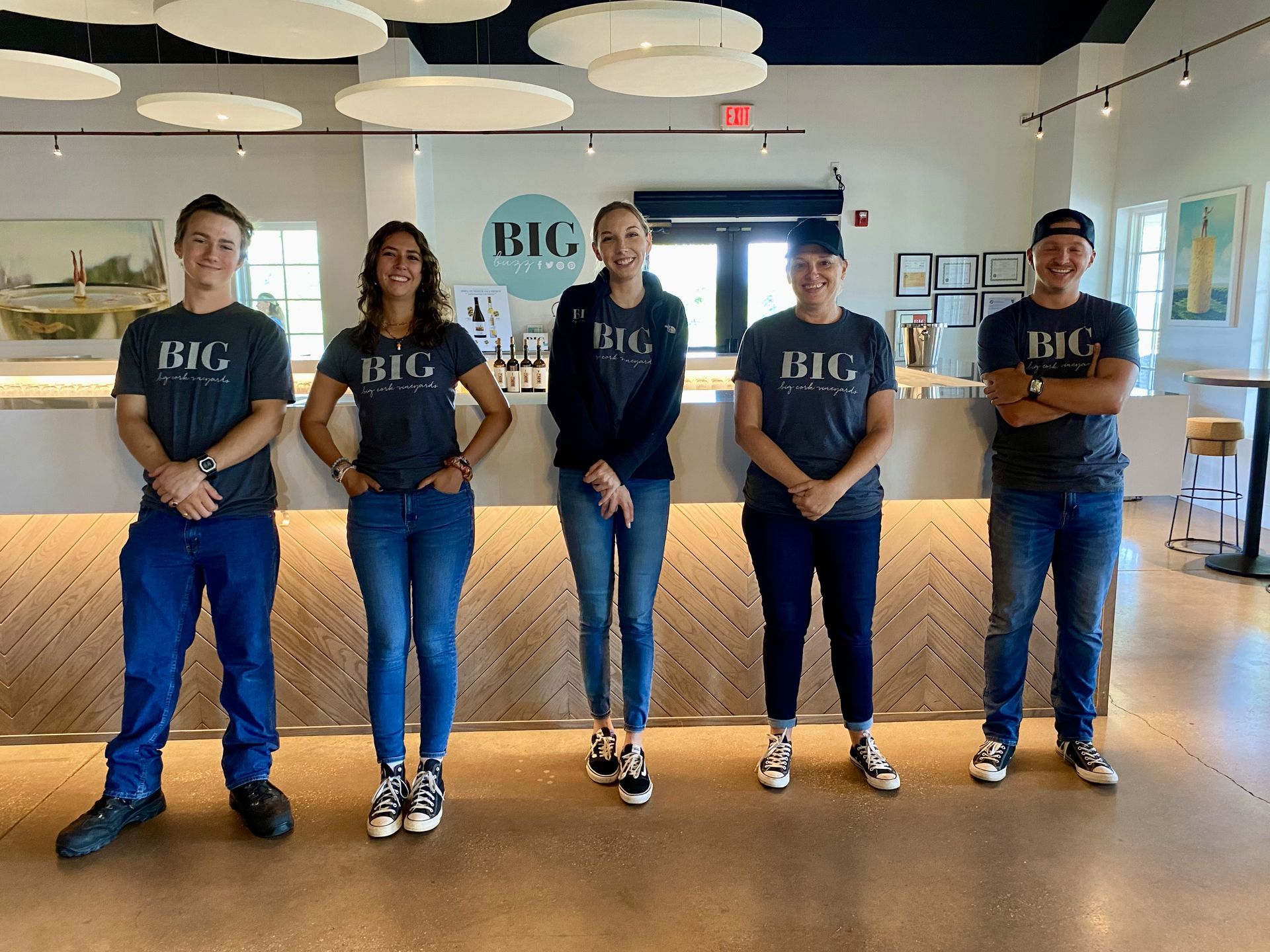 A group of people standing next to each other in front of a counter.