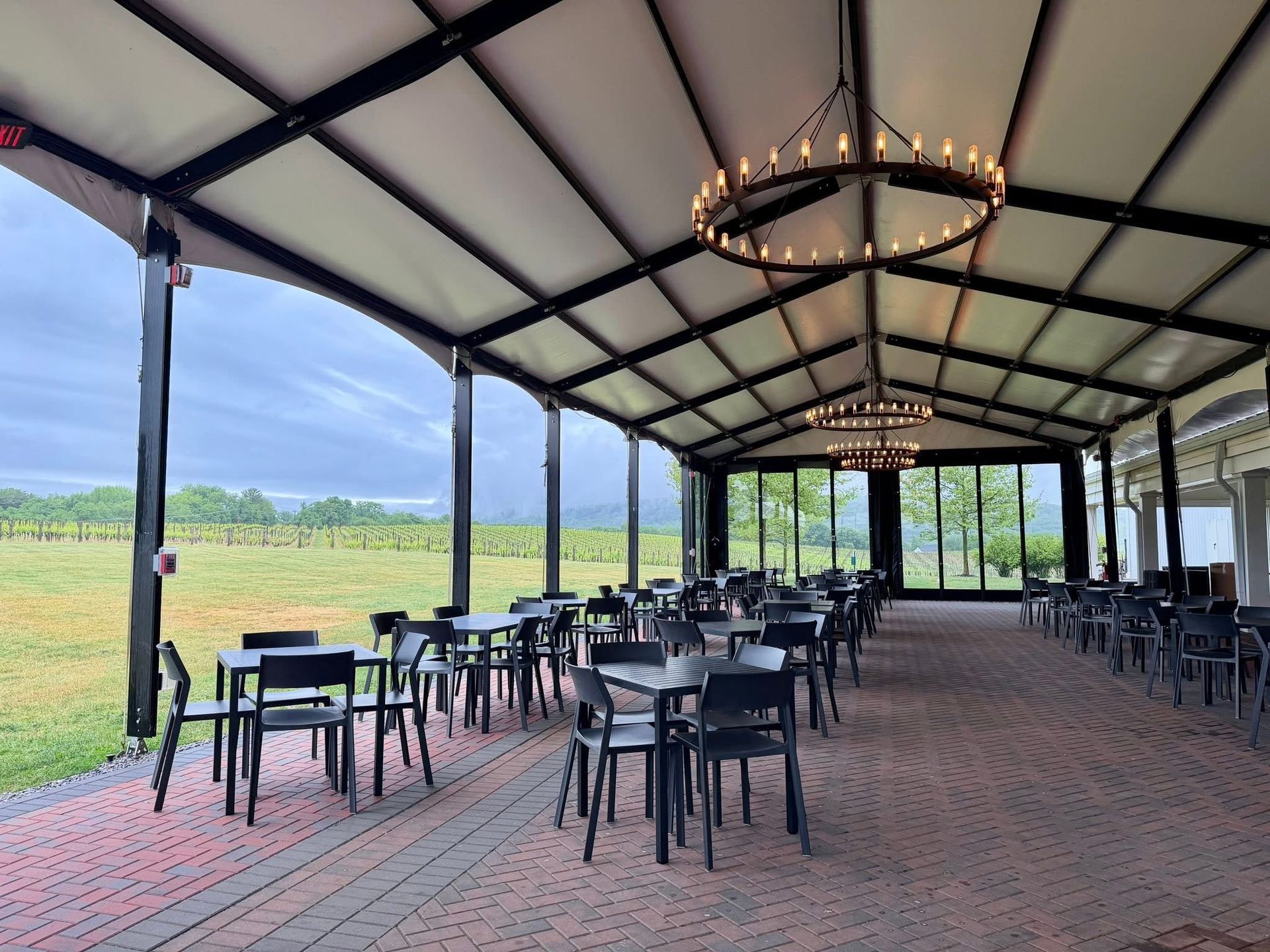 Expansive patio with ample seating and vineyard views. 