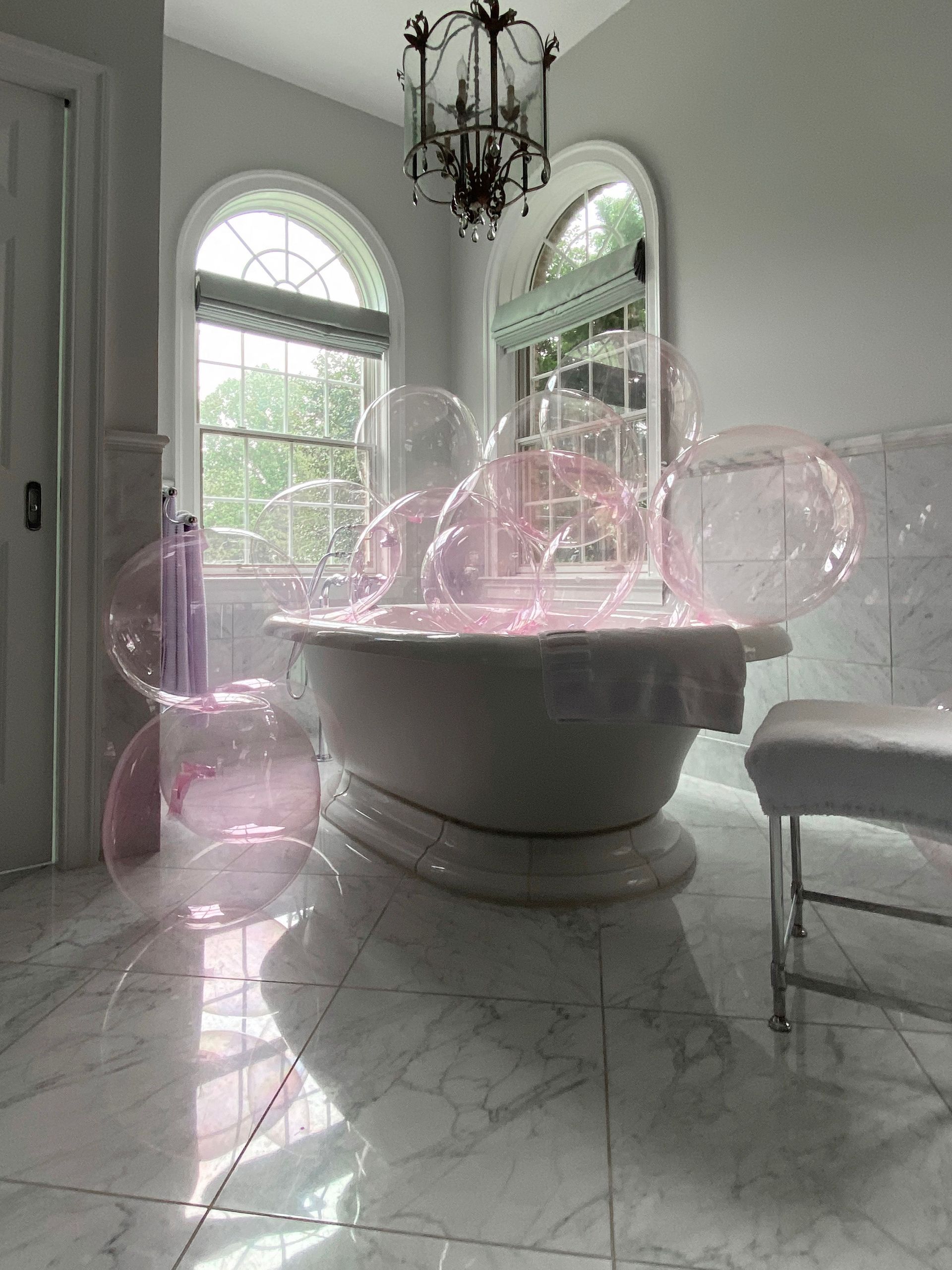 A bathtub in a bathroom with bubbles coming out of it