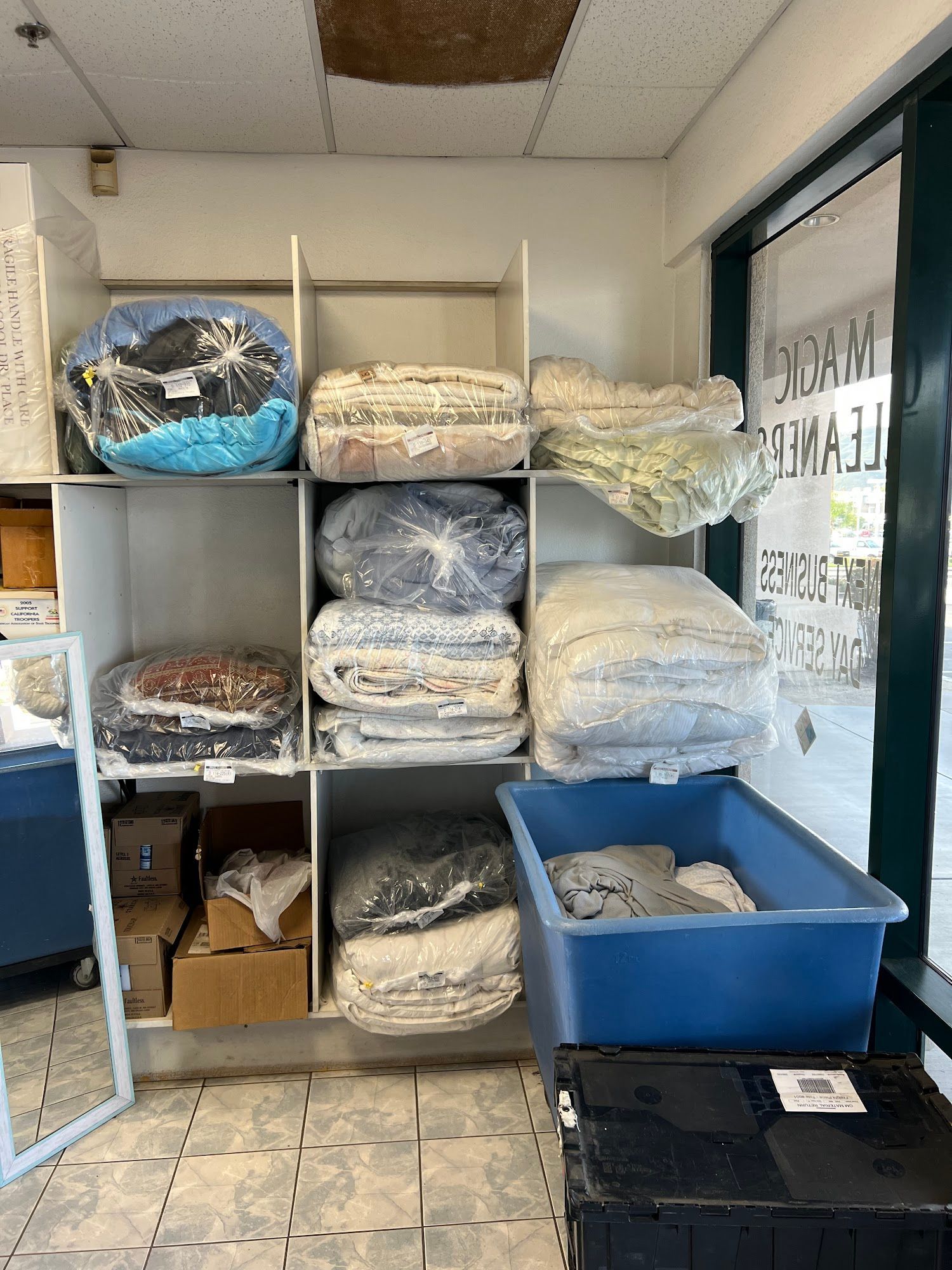 The inside of a moving truck filled with boxes and blankets.
