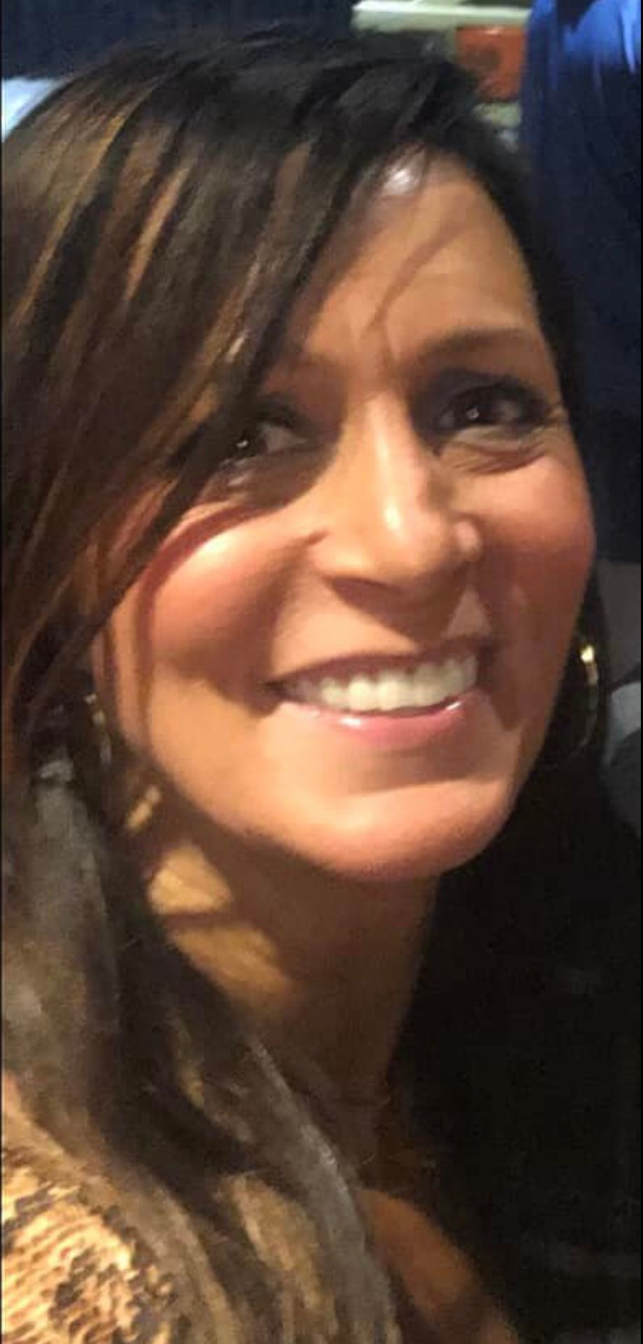 A close up of a woman 's face smiling.