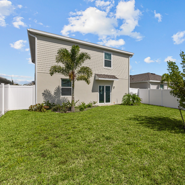 A house with a large lawn in front of it