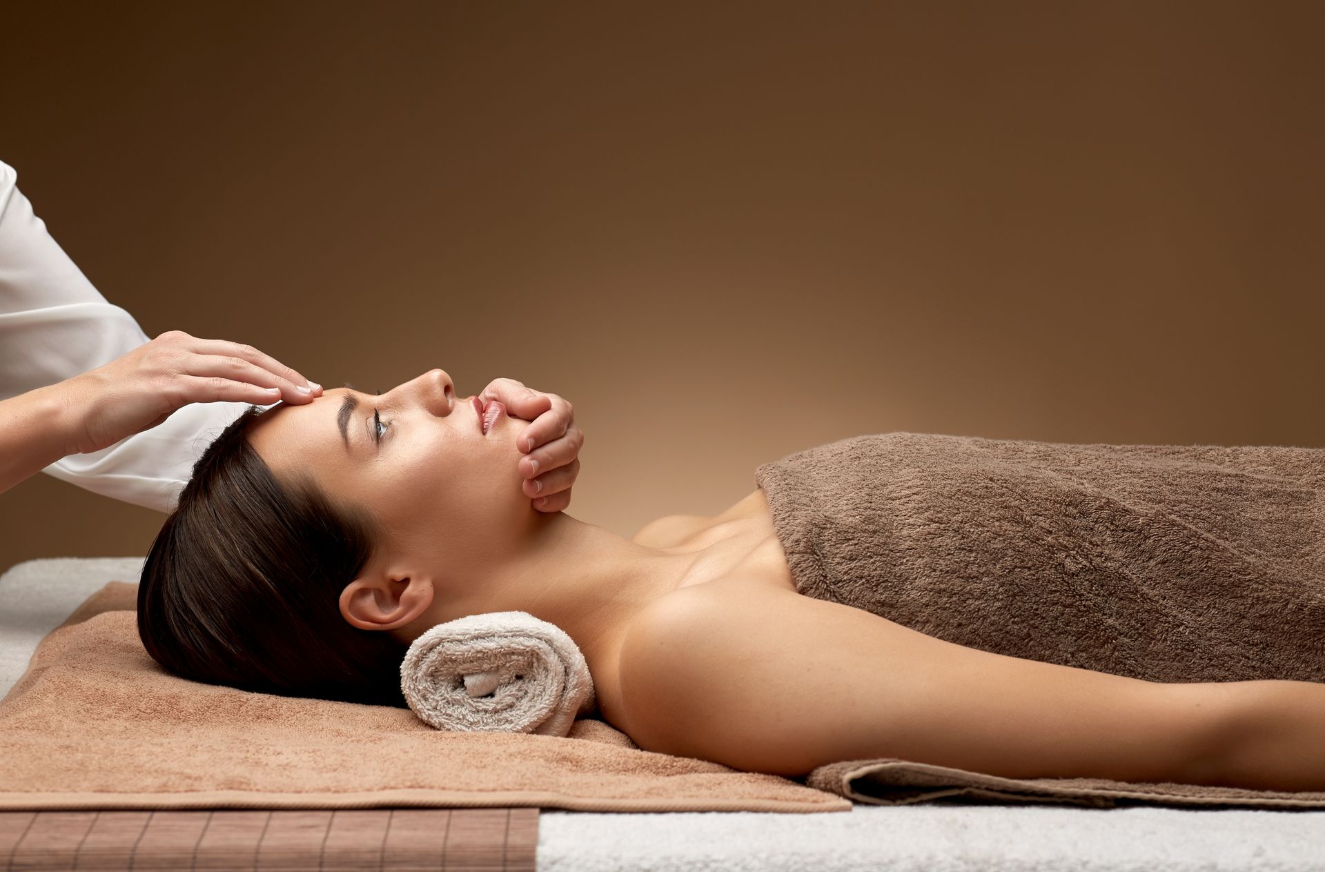 Eine Frau bekommt in einem Spa eine Gesichtsmassage.