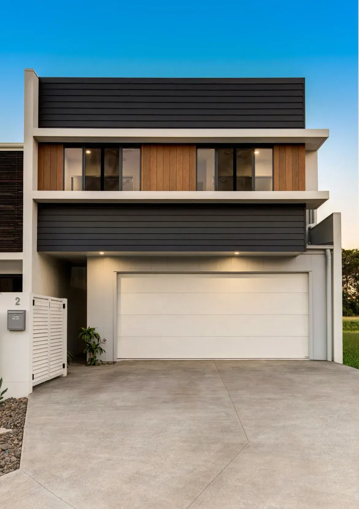 A Modern House With a White Garage Door — O'Brien Painting Contractors in Nambour, QLD