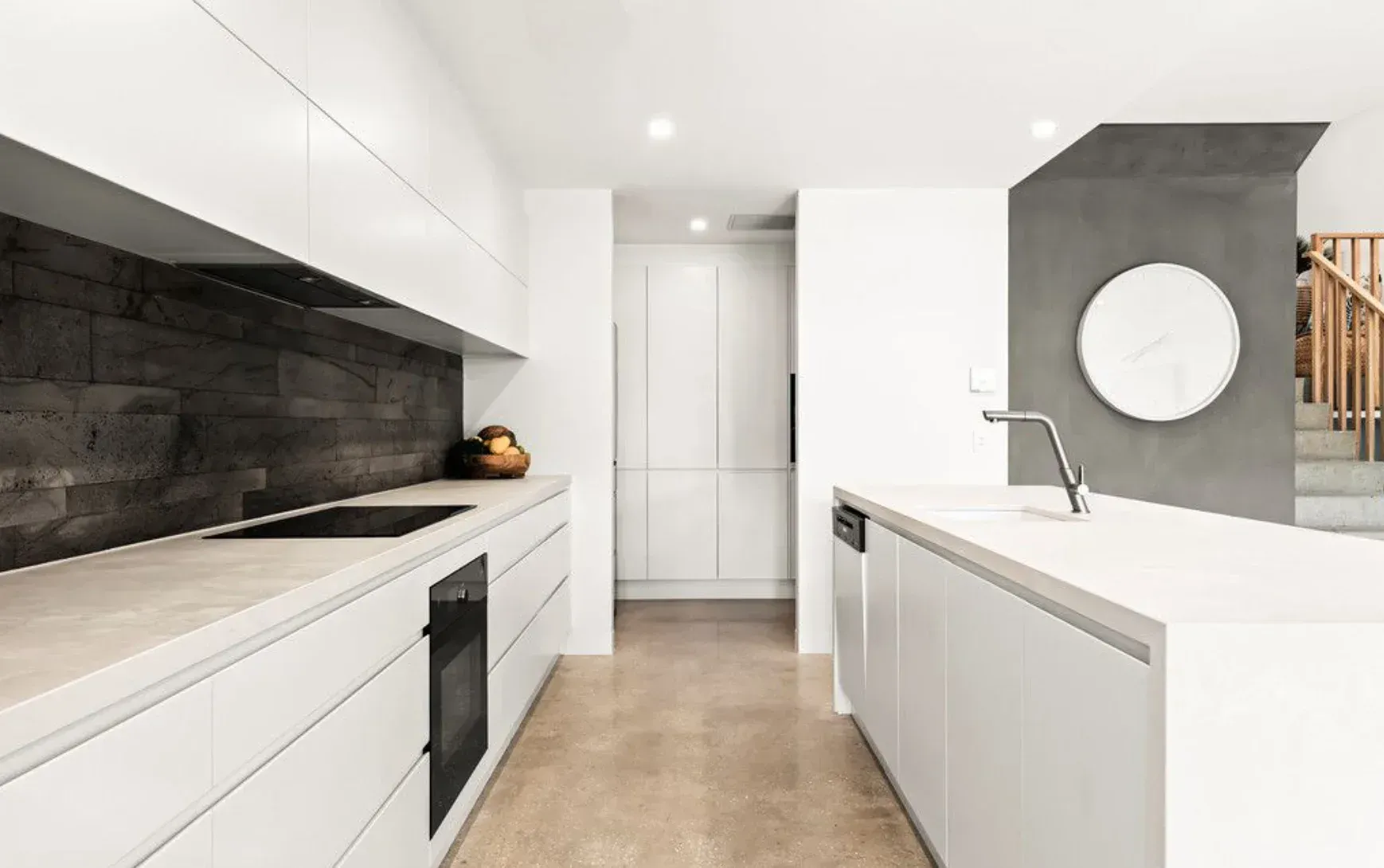 A Kitchen With White Cabinets,  a Sink, a Stove, and a Mirror — O'Brien Painting Contractors in Alexandra Headland, QLD