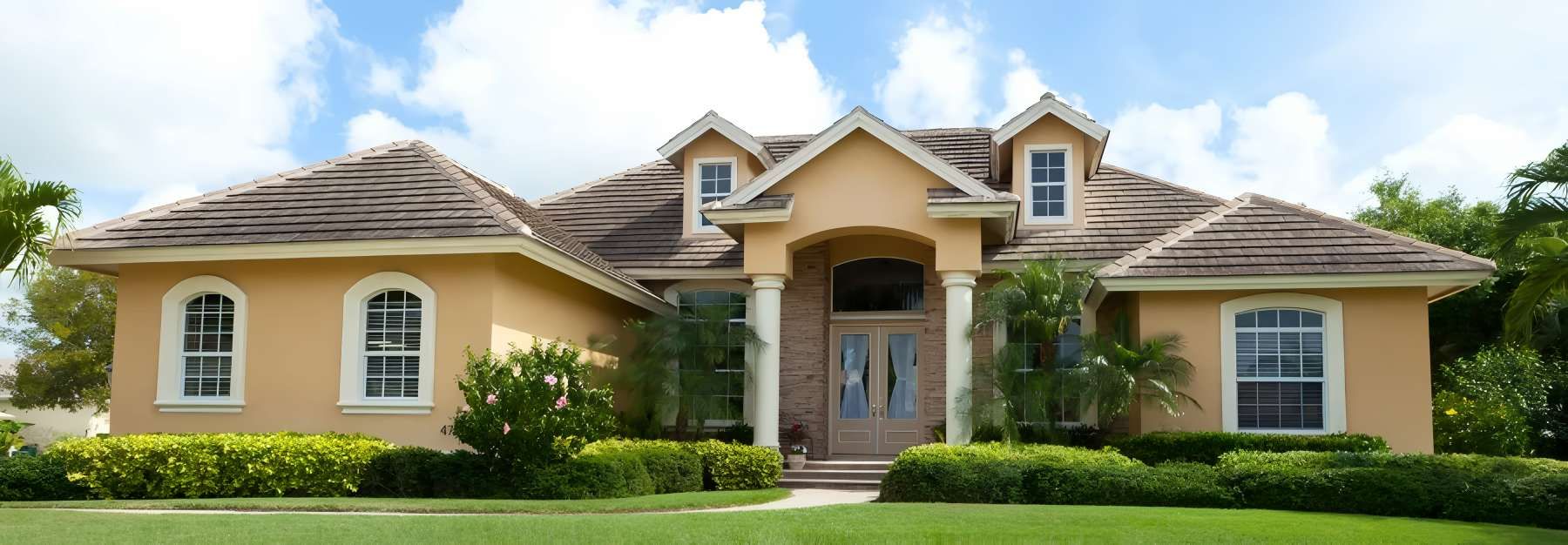 A Large House With a Lush Green Lawn in Front of It — O'Brien Painting Contractors in Alexandra Headland, QLD
