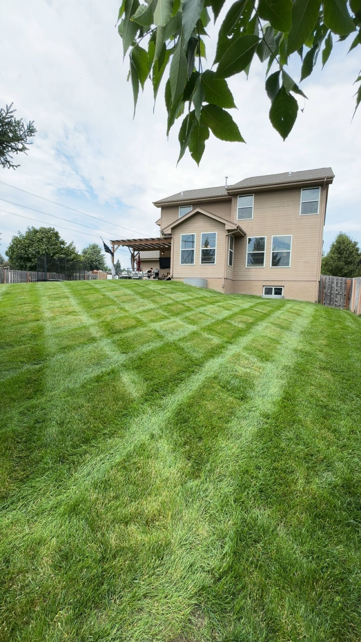 A Large House With a Lush Green Lawn in Front of It
