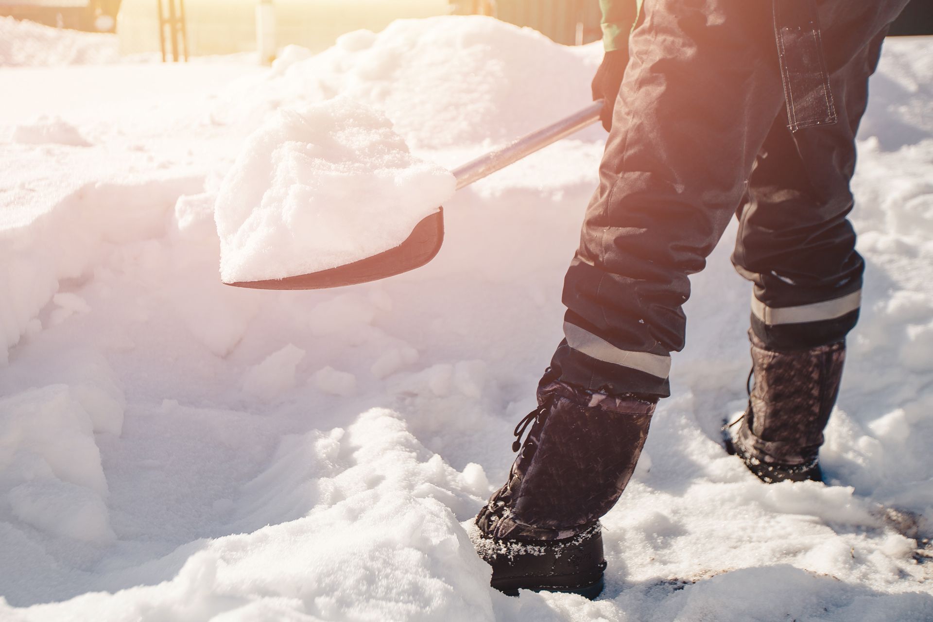 A Person is Shoveling Snow From the Ground With a Shovel