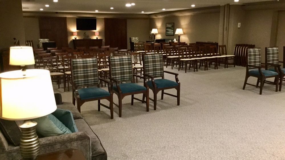 A large room with a lot of chairs and lamps.