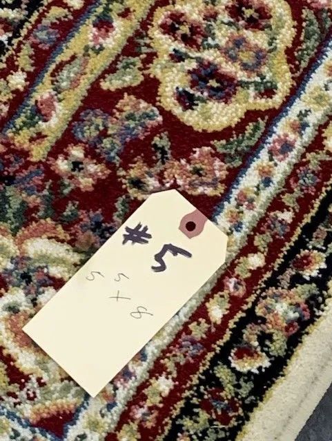 A rug with a tag that says # 5 on it