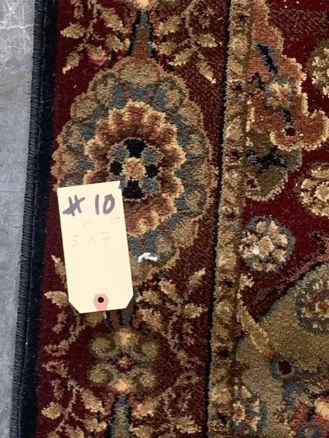 A red rug with a tag that says x 10 on it