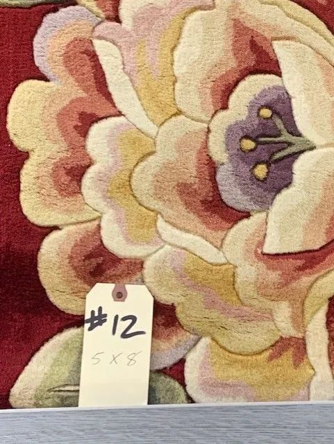 A rug with a tag that says # 12 on it