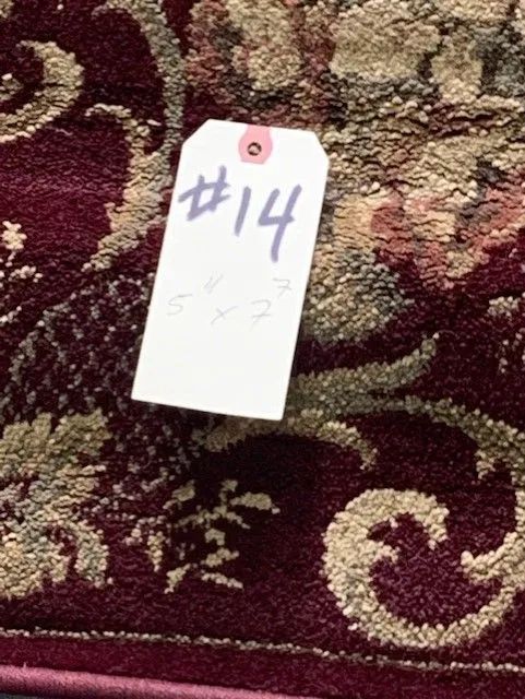 A purple rug with a tag that says # 14 on it