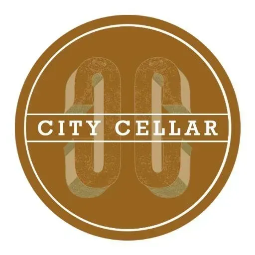 A brown circle with the words city cellar on it